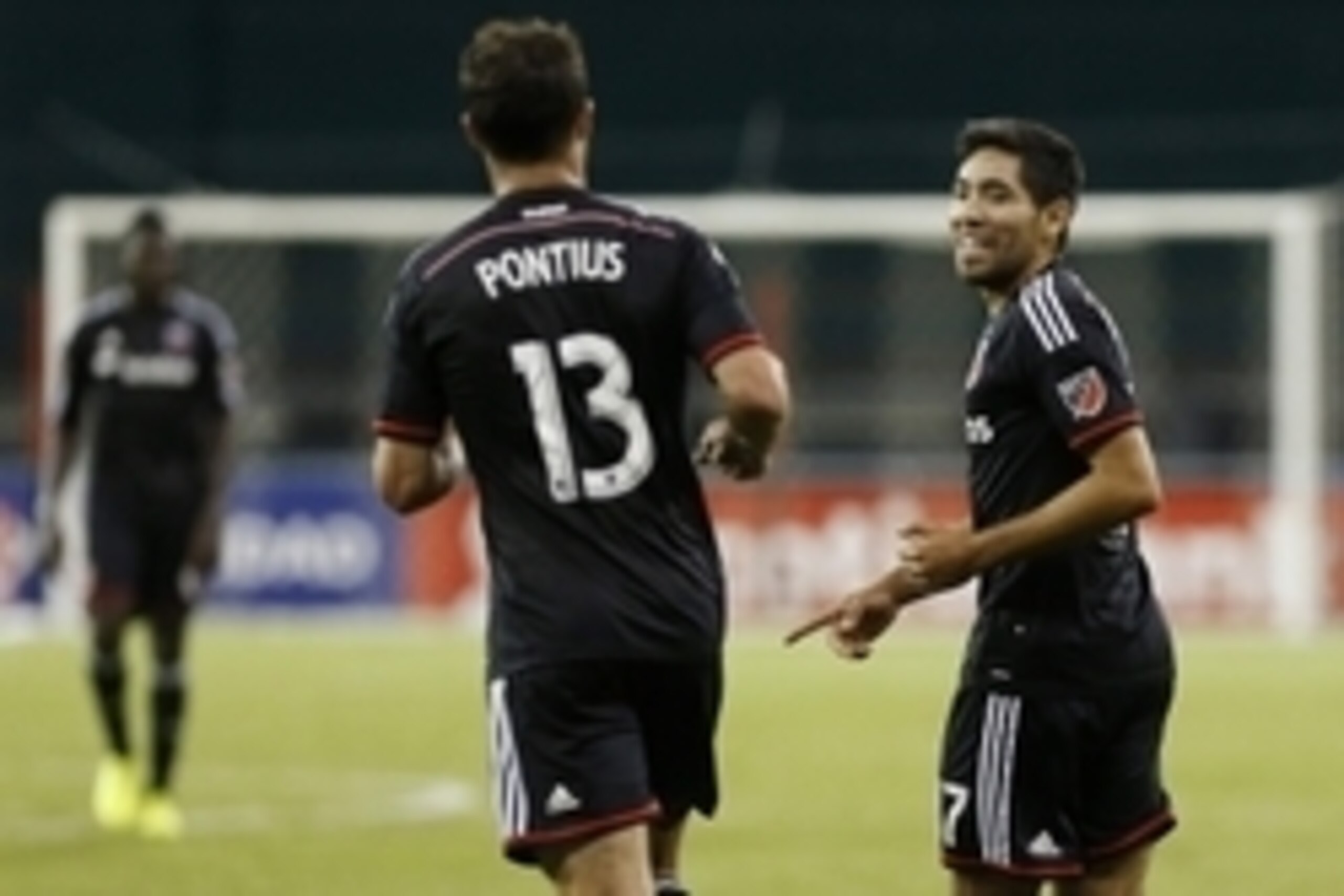 Aug 25, 2015; Washington, DC, USA; D.C. United midfielder Miguel Aguilar (17) celebrates with midfielder/forward Chris Pontius (13) after scoring a goal against Montego Bay F.C. in the first half at RFK Stadium. United won 3-0. Mandatory Credit: Geoff Bur