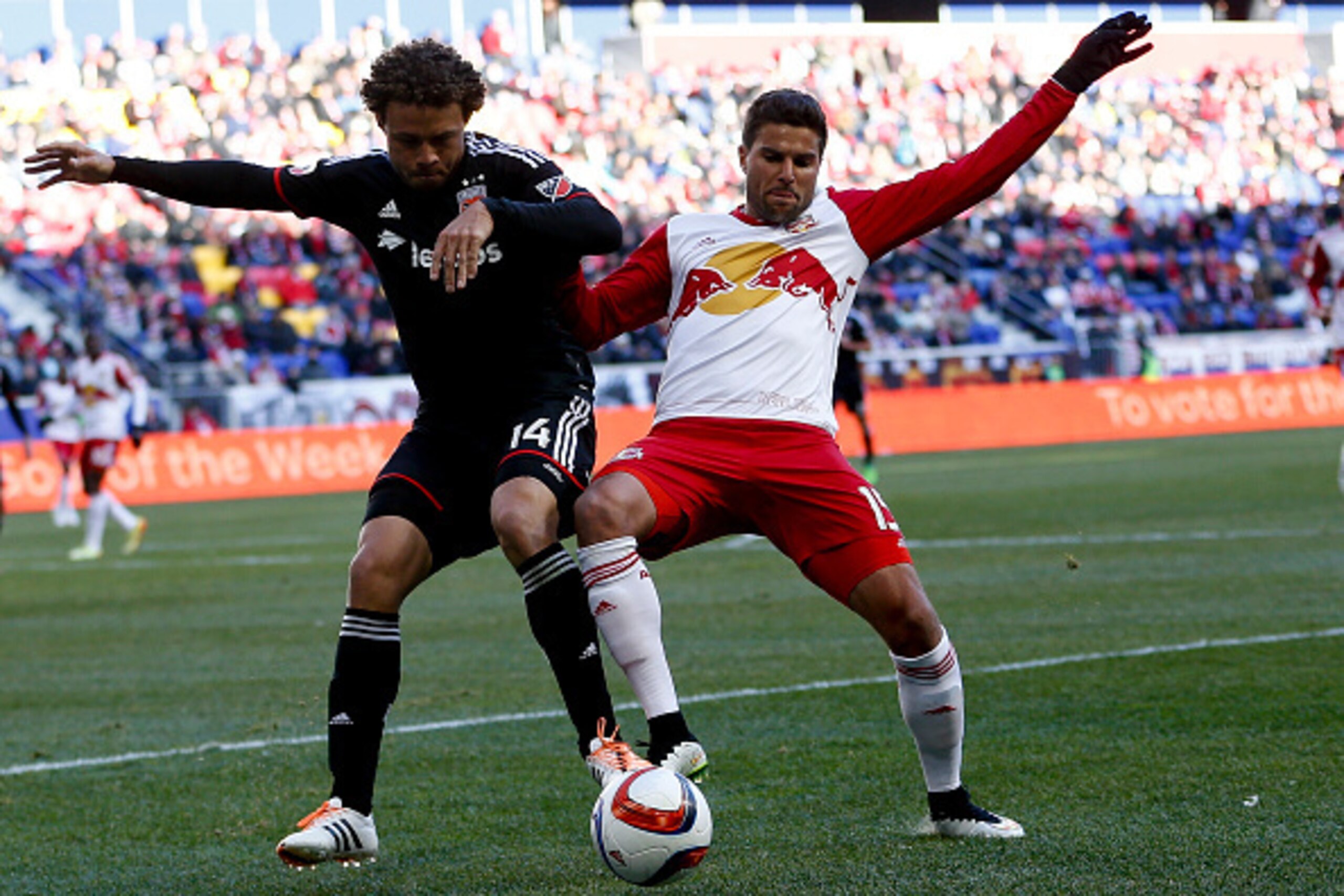 HARRISON, NJ - MARCH 22:  Nick DeLeon #14 of D.C. United battles for the ball with Sal Zizzo #15 of New York Red Bulls during their match at Red Bull Arena on March 22, 2015 in Harrison, New Jersey.  (Photo by Jeff Zelevansky/Getty Images)