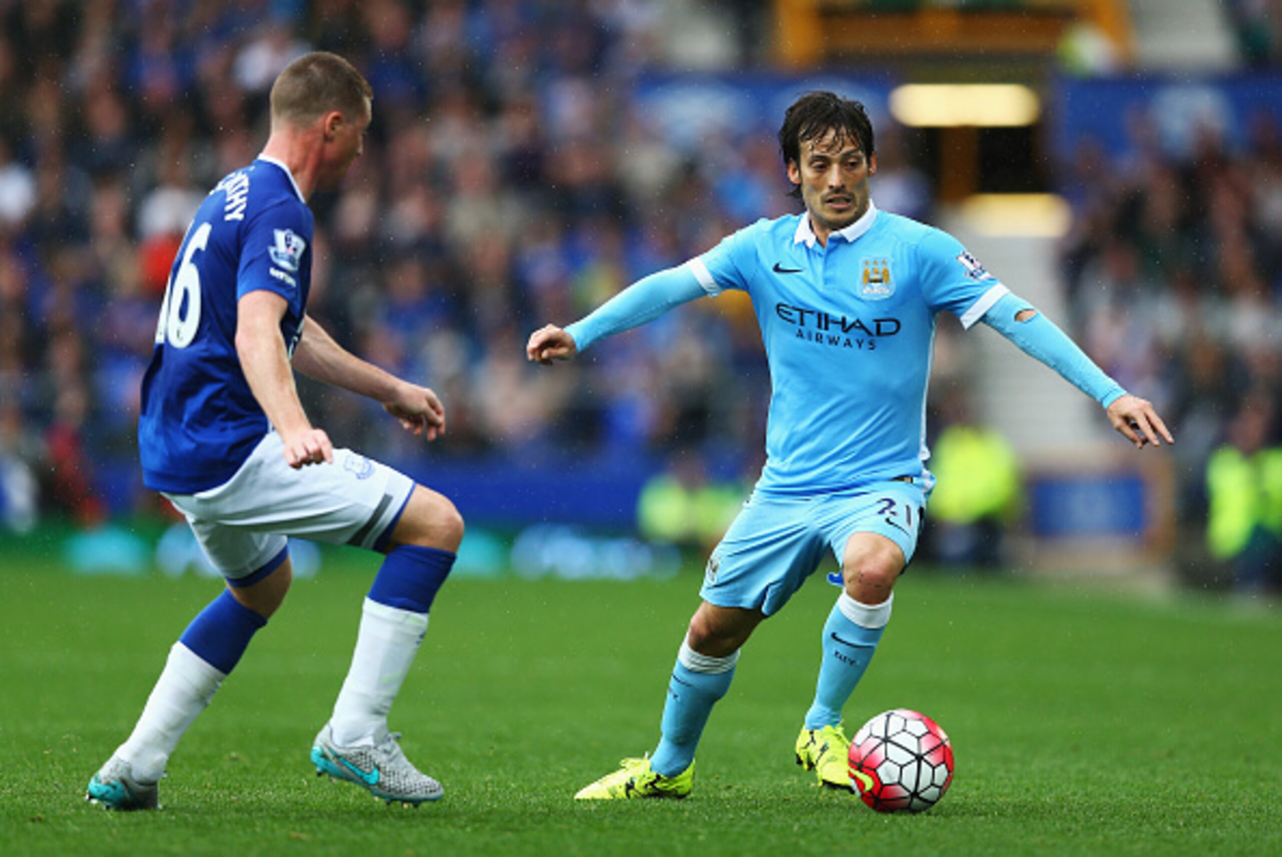LIVERPOOL, ENGLAND - AUGUST 23: David Silva of Manchester City takes on James McCarthy of Everton during the Barclays Premier League match between Everton and Manchester City at Goodison Park on August 23, 2015 in Liverpool, England.  (Photo by Clive Brun