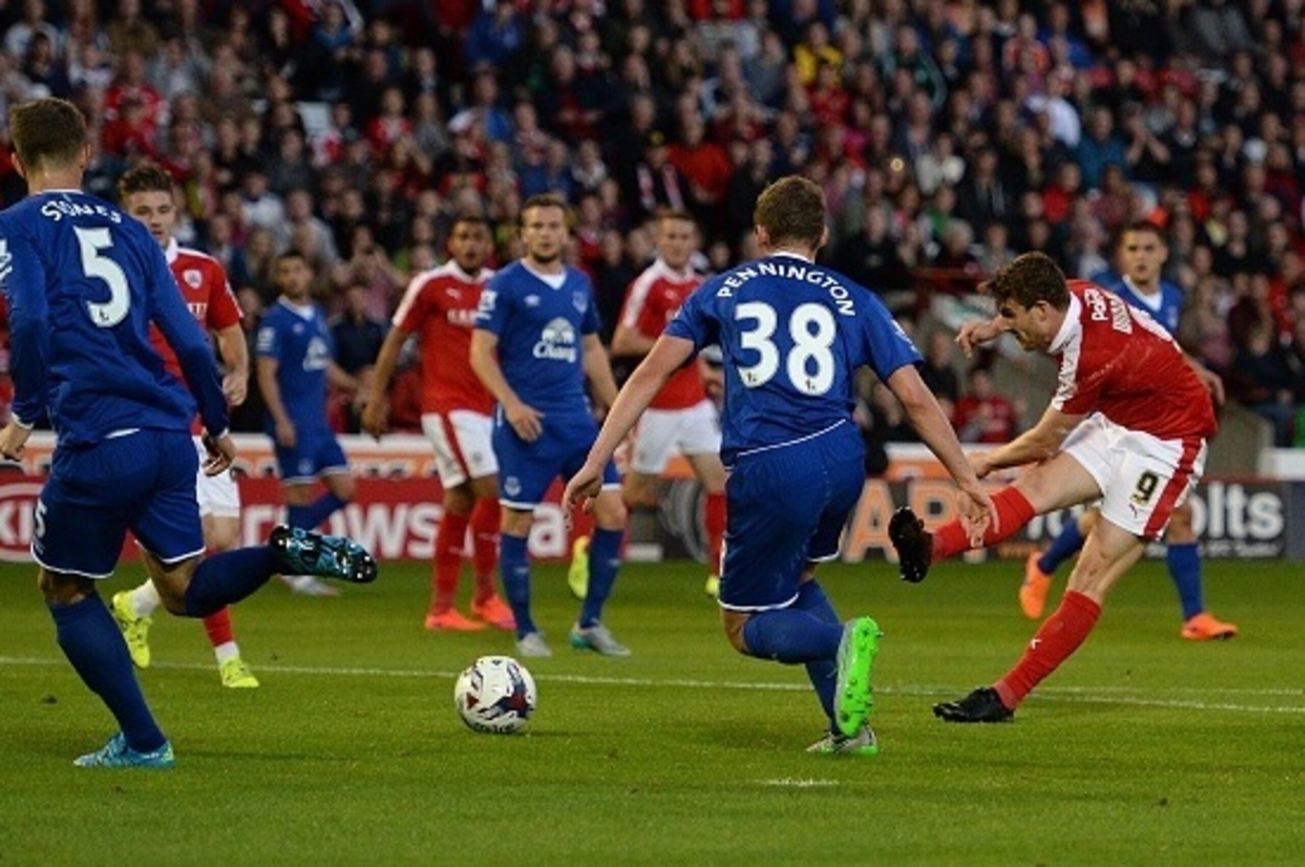 Barnsley's English forward Sam Winnall (R) shoots to score a goal during the English League Cup football match between Barnsley and Everton at the Oakwell Stadium in Barnsley, England, on August 26, 2015.    AFP PHOTO / OLI SCARFF

RESTRICTED TO EDITORIAL
