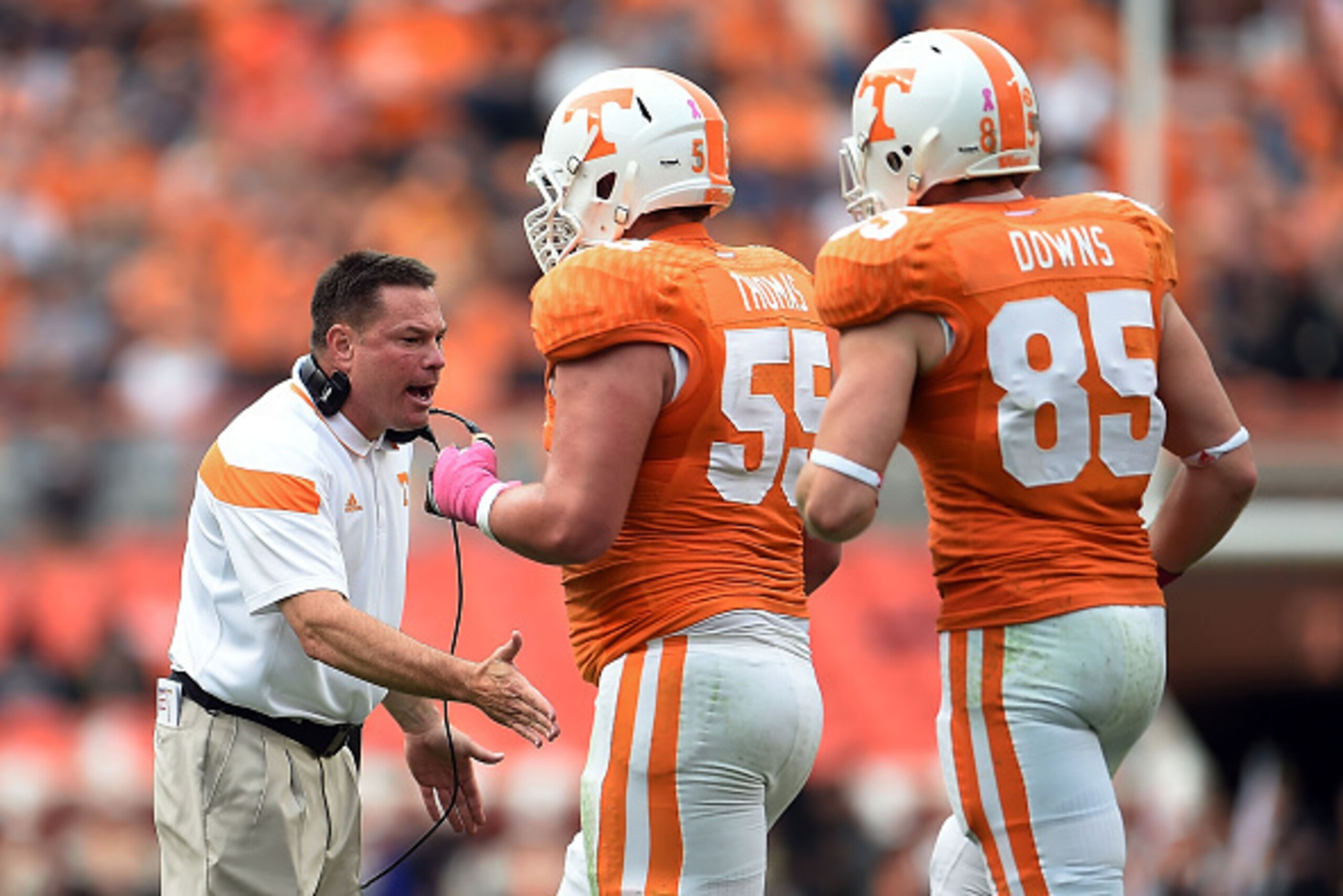KNOXVILLE, TN - OCTOBER 11:  Coleman Thomas #55 and Brendan Downs #85 of the Tennessee Volunteers are congratulated by head coach Butch Jones during a game against the Chattanooga Mocs at Neyland Stadium on October 11, 2014 in Knoxville, Tennessee. Tennes