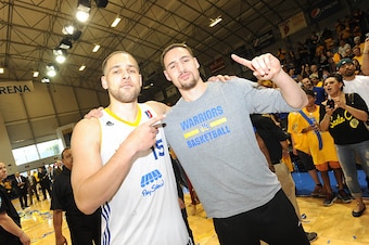 SANTA CRUZ, CA - APRIL 26: Mychel Thompson #15 of the Santa Cruz Warriors celebrates with Klay Thompson #11 of the Golden State Warriors after winning the NBA D-League Championship defeating the Fort Wayne Mad Ants in Game Two of the NBA D-League Finals o