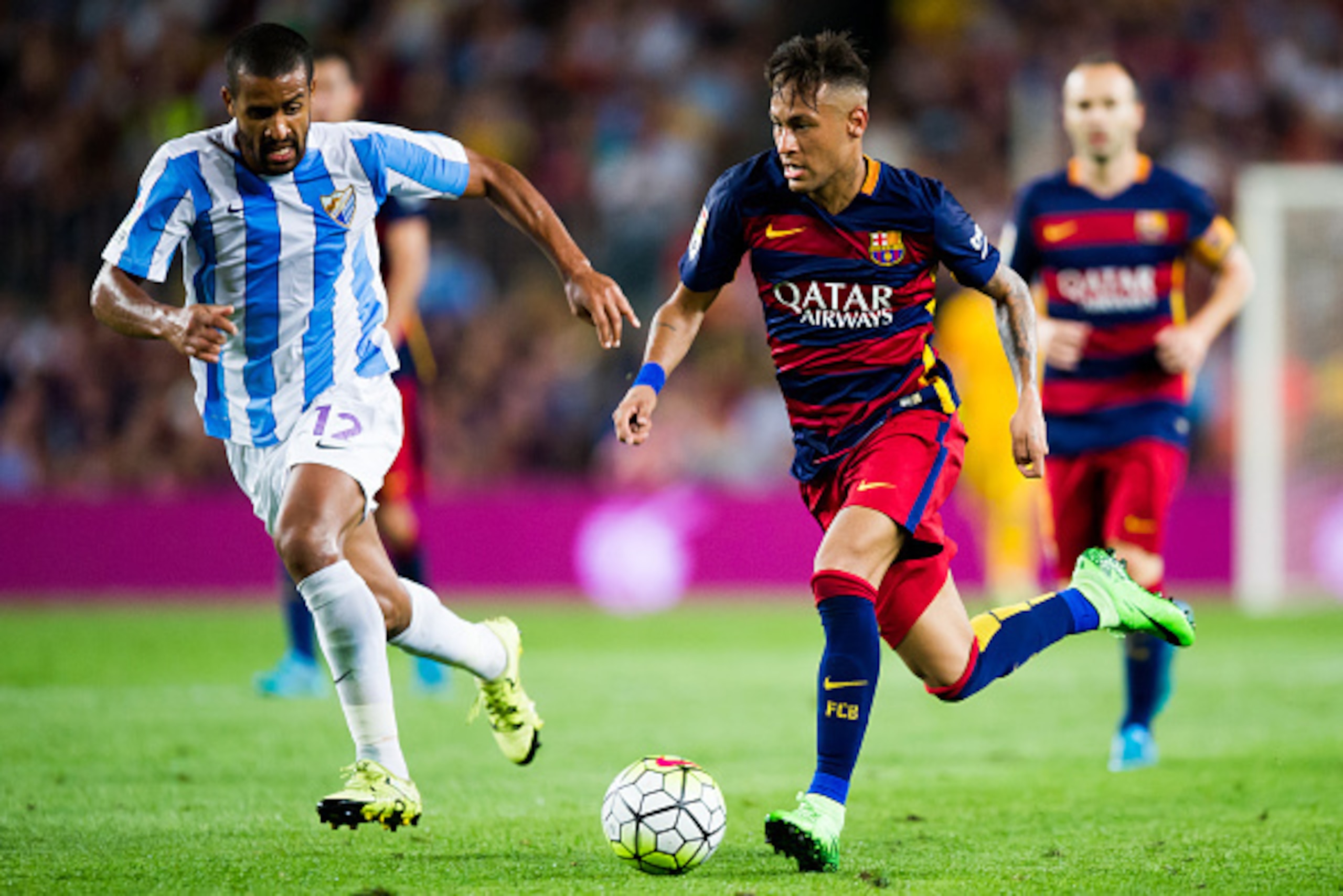 BARCELONA, SPAIN - AUGUST 29: Neymar Santos Jr (R) of FC Barcelona conducts the ball next to Fernando Tissone of Malaga CF during the La Liga match between FC Barcelona and Malaga CF at Camp Nou on August 29, 2015 in Barcelona, Spain. (Photo by Alex Capar