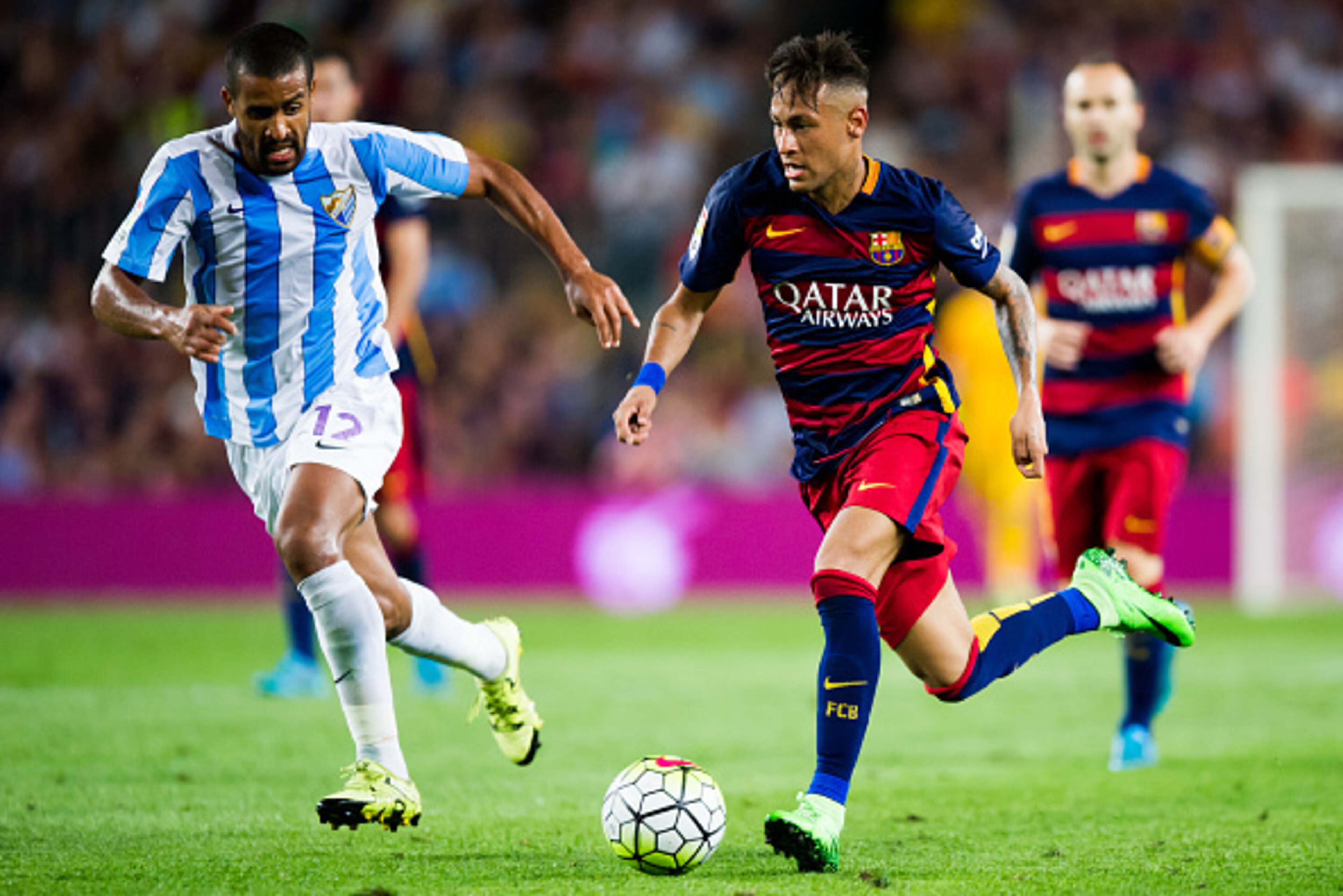 BARCELONA, SPAIN - AUGUST 29: Neymar Santos Jr (R) of FC Barcelona conducts the ball next to Fernando Tissone of Malaga CF during the La Liga match between FC Barcelona and Malaga CF at Camp Nou on August 29, 2015 in Barcelona, Spain. (Photo by Alex Capar