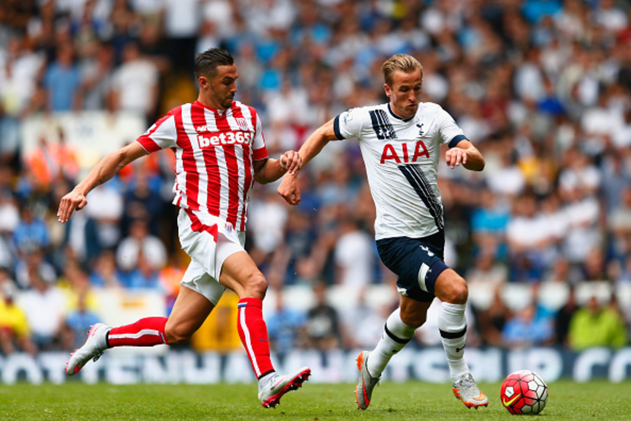 LONDON, ENGLAND - AUGUST 15: Harry Kane of Tottenham Hotspur and Geoff Cameron of Stoke City compete for the ball during the Barclays Premier League match between Tottenham Hotspur and Stoke City at White Hart Lane on August 15, 2015 in London, United Kin