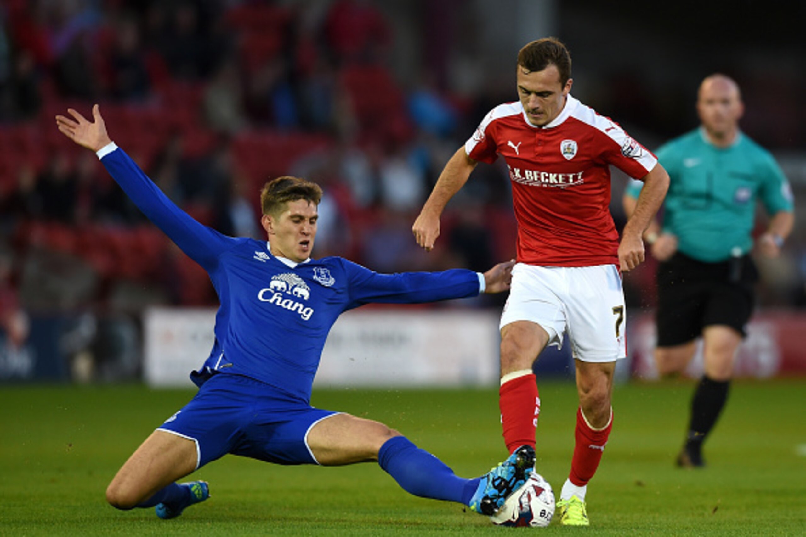 BARNSLEY, ENGLAND - AUGUST 26:  John Stones of Everton tackles Josh Scowen of Barnsley during the Capital One Cup second round match between Barnsley and Everton at Oakwell Stadium on August 26, 2015 in Barnsley, England.  (Photo by Michael Regan/Getty Im