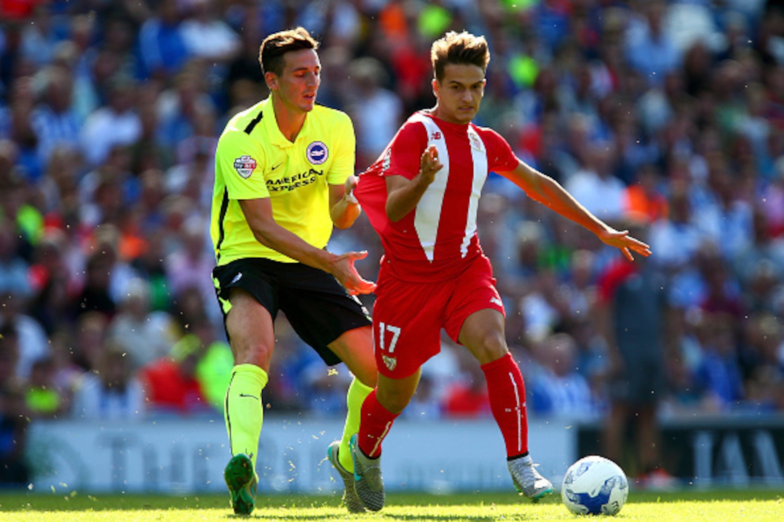 BRIGHTON, ENGLAND - AUGUST 02:  Lewis Dunk of Brighton tugs the shirt of Denis Suarez of Sevilla during the Pre Season Friendly between Brighton & Hove Albion and Seville at Amex Stadium on August 2, 2015 in Brighton, England.  (Photo by Jordan Mansfield/