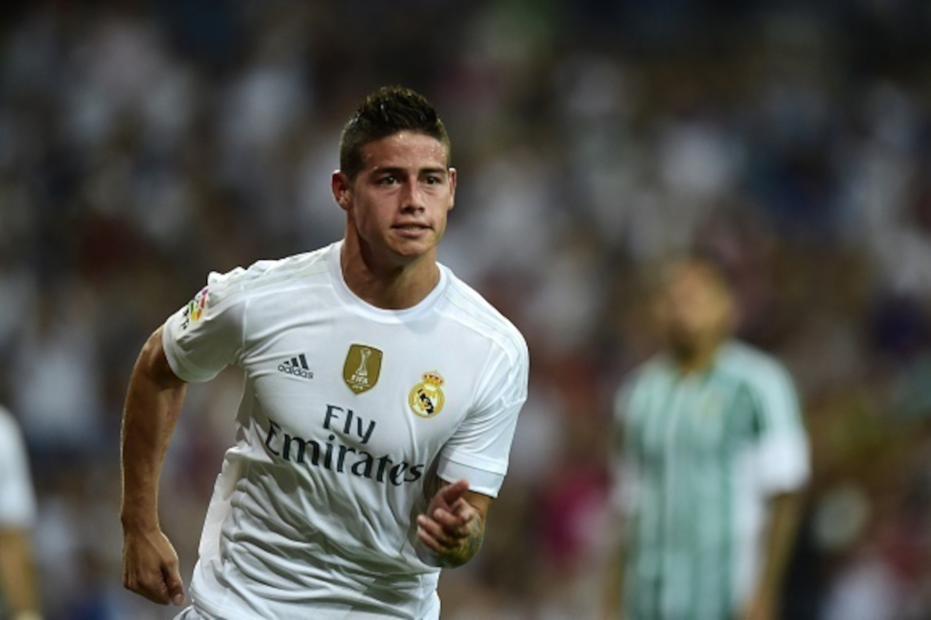 Real Madrid's Colombian midfielder James Rodriguez celebrates after scoring during the Spanish league football match Real Madrid CF vs Real Betis Balompie at the Santiago Bernabeu stadium in Madrid on August 29, 2015.   AFP PHOTO/ PIERRE-PHILIPPE MARCOU  