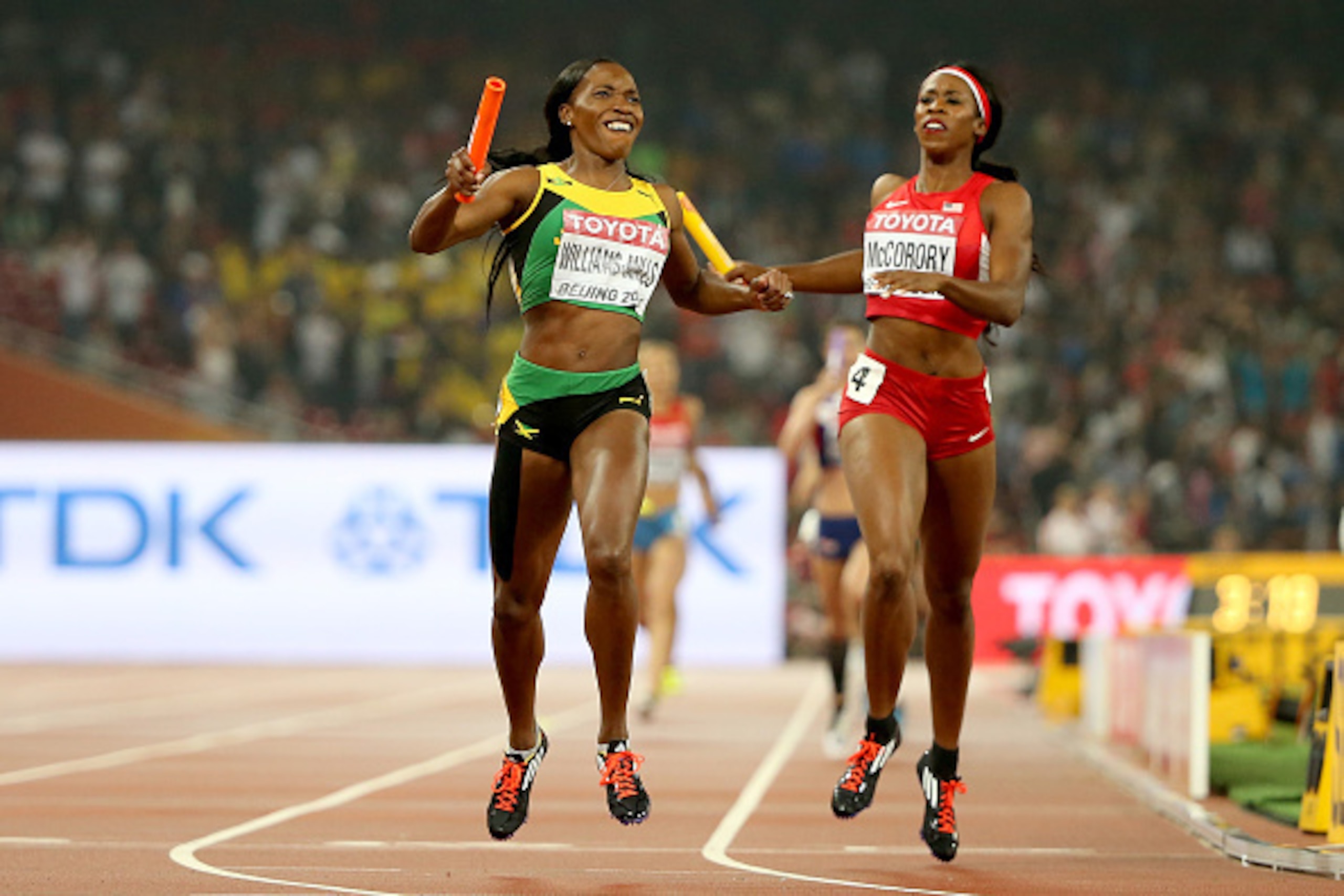BEIJING, CHINA - AUGUST 30:  Novlene Williams-Mills of Jamaica crosses the line to win gold ahead of Francena McCorory of the United States in the Women's 4x400 Relay Final during day nine of the 15th IAAF World Athletics Championships Beijing 2015 at Bei