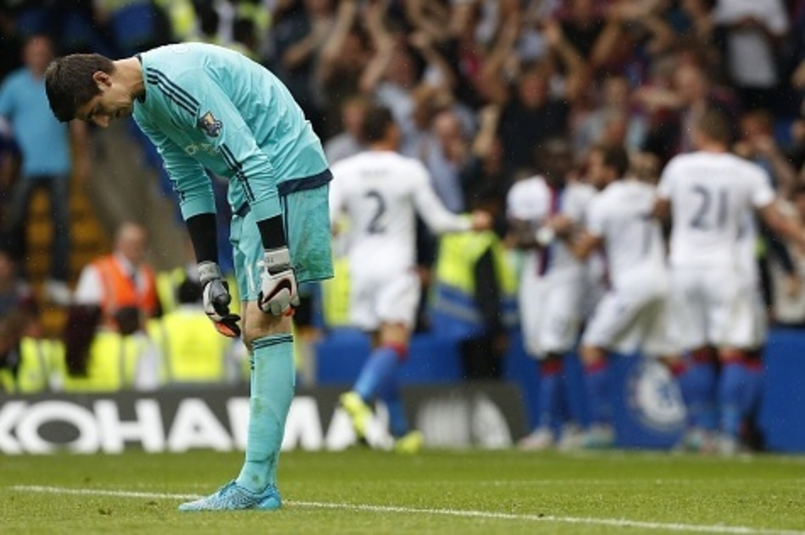 Chelseas Belgian goalkeeper Thibaut Courtois reacts as the Crystal Palace team celebrate Crystal Palaces first goal during the English Premier League football match between Chelsea and Crystal Palace at Stamford Bridge in London on August 29, 2015. Crysta Chelseas Belgian goalkeeper Thibaut Courtois reacts as the Crystal Palace team celebrate Crystal Palaces first goal during the English Premier League football match between Chelsea and Crystal Palace at Stamford Bridge in London on August 29, 2015. Crysta