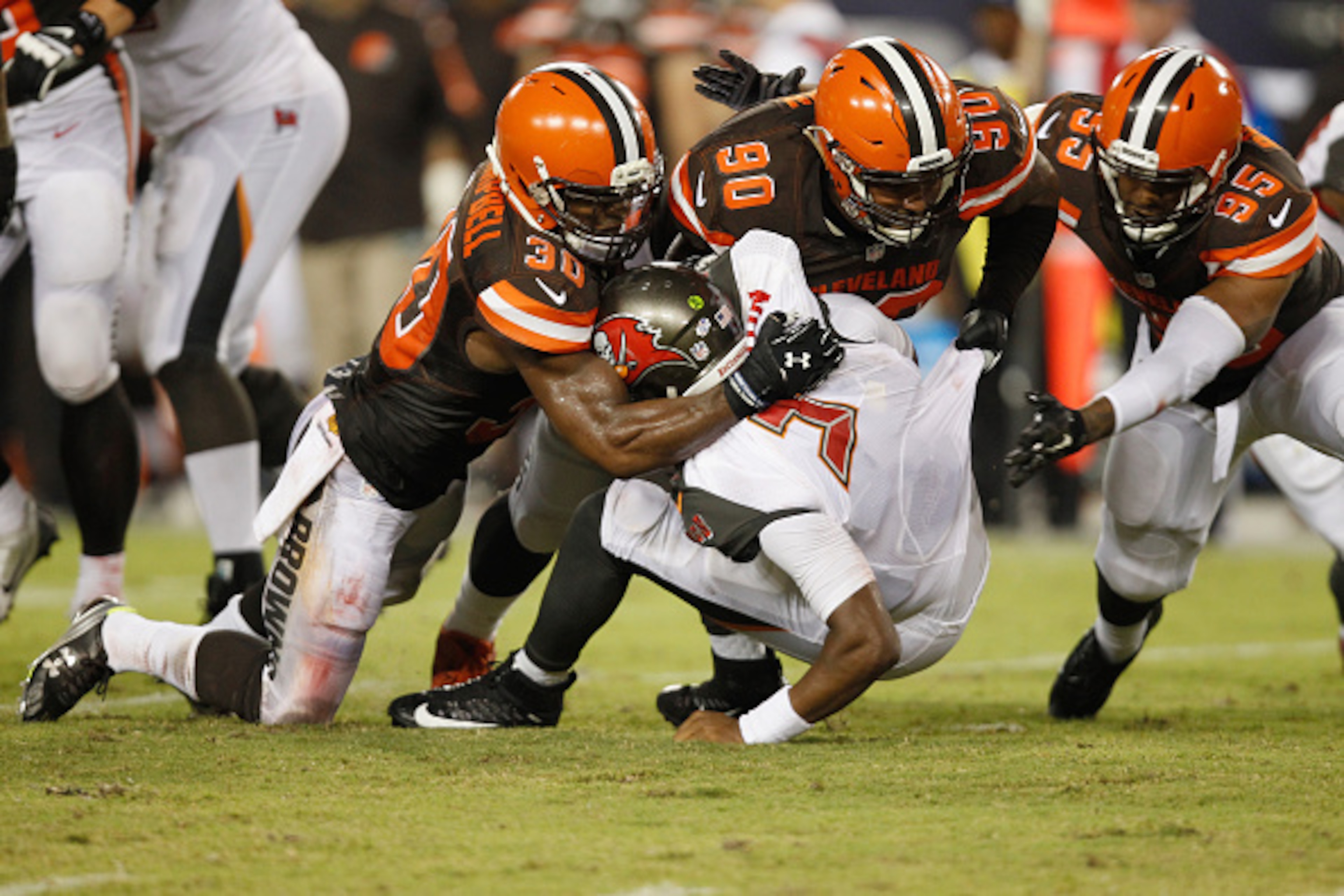 TAMPA, FL - AUGUST 29:  Quarterback Jameis Winston #3 of the Tampa Bay Buccaneers gets sacked by strong safety Ibraheim Campbell #30 of the Cleveland Browns, defensive end Billy Winn #90 and wide receiver Vince Mayle #85 during the first half of the prese