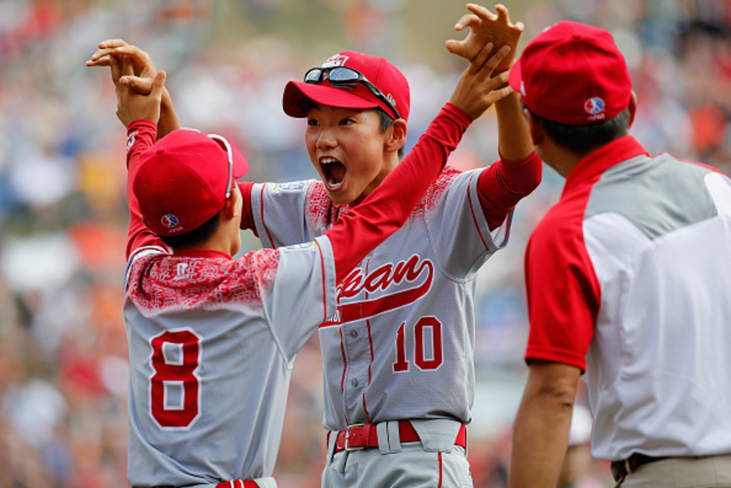 SOUTH WILLAMSPORT, PA - AUGUST 29: Shingo Tomita #10 and Yuta Komaba #8 of team Japan celebrate after after defeating team Mexico during the International Championship game of the Little League World Series at Lamade Stadium on August 29, 2015 in South Wi