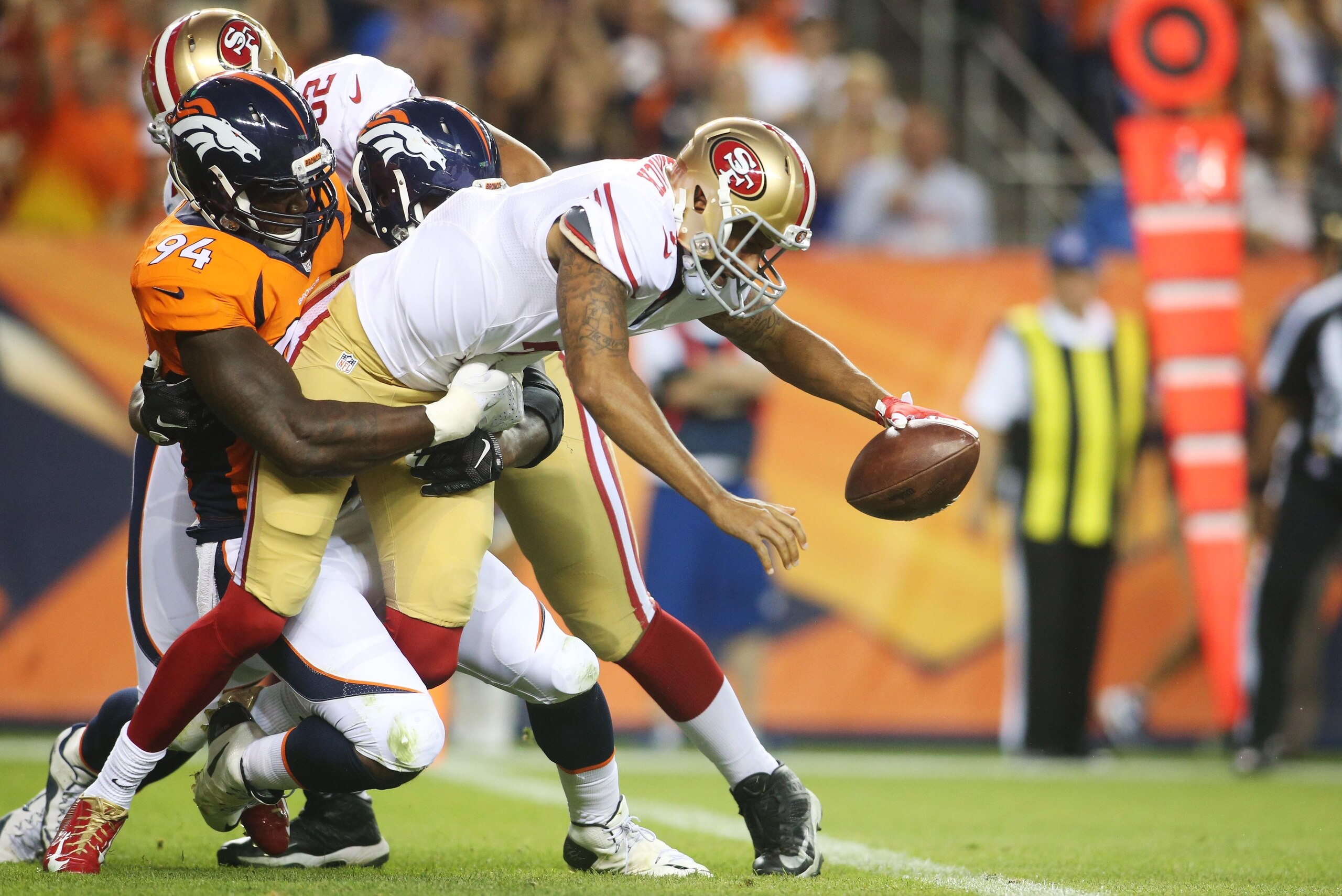 Aug 29, 2015; Denver, CO, USA; San Francisco 49ers quarterback Colin Kaepernick (7) is sacked by Denver Broncos defensive end DeMarcus Ware (94) during the first half at Sports Authority Field at Mile High. Mandatory Credit: Chris Humphreys-USA TODAY Spor