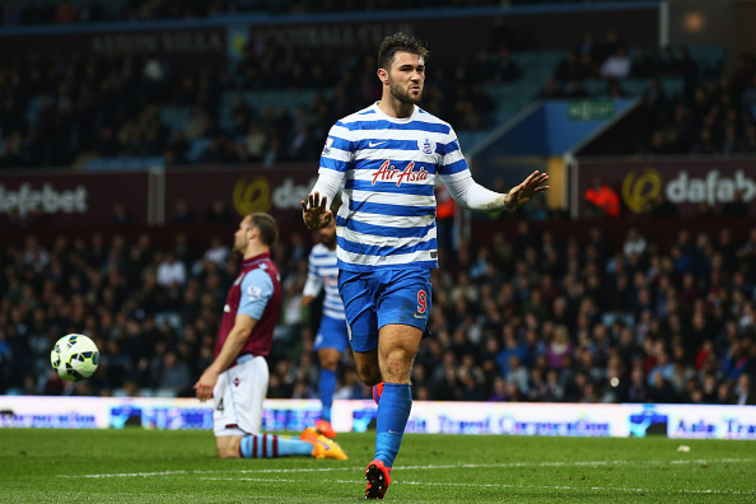 BIRMINGHAM, ENGLAND - APRIL 07:  Ron Vlaar of Aston Villa (L) look dejected as  Charlie Austin of QPR (9) celebrates as he scores their third goal during the Barclays Premier League match between Aston Villa and Queens Park Rangers at Villa Park on April 
