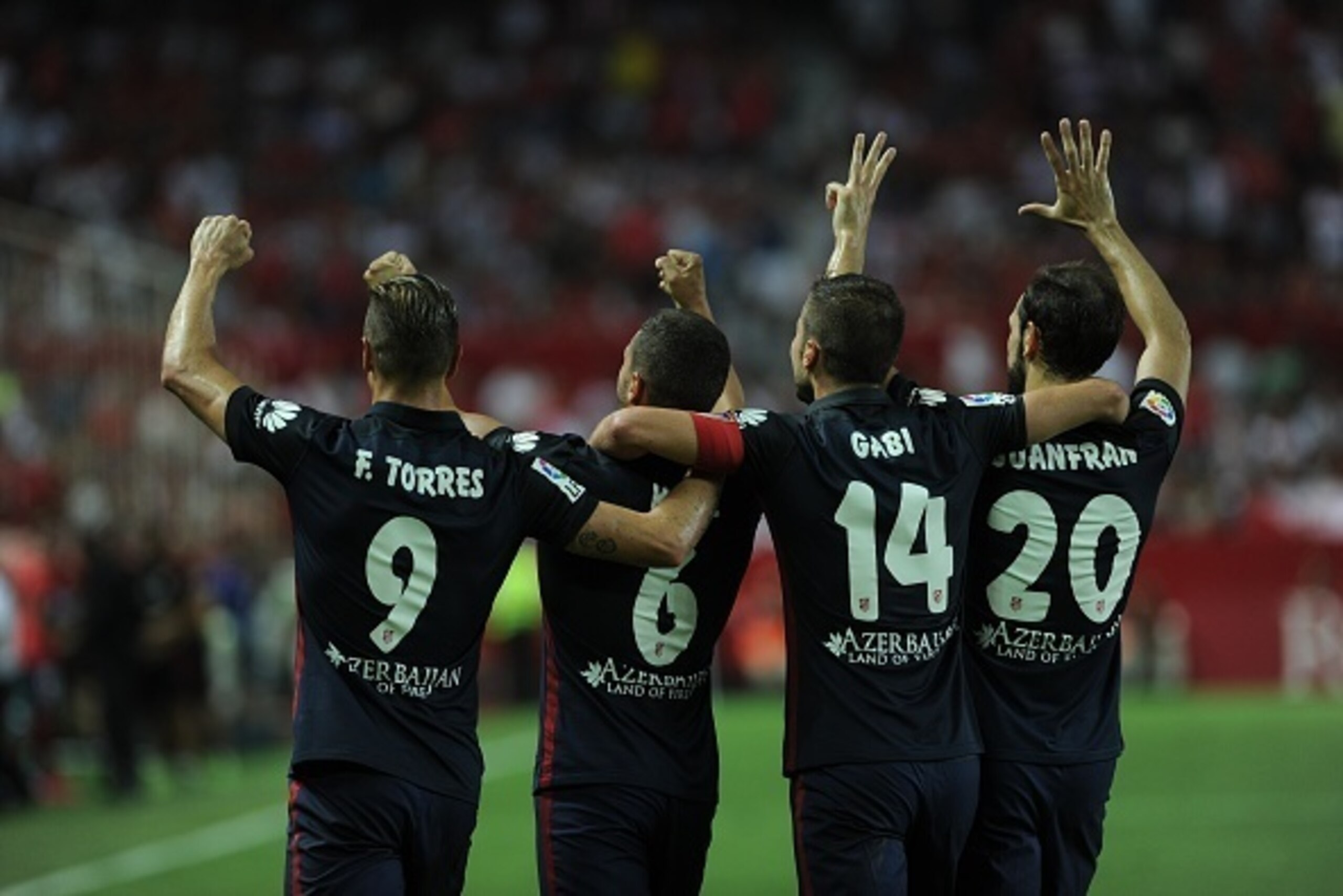 Atletico Madrid's midfielder Koke (2L) celebrates with Atletico Madrid's Croatian forward Mario Mandzukic, Atletico Madrid's midfielder Gabi and Atletico Madrid's defender Juanfran after scoring during the Spanish league football match Sevilla FC vs Club Atletico Madrid's midfielder Koke (2L) celebrates with Atletico Madrid's Croatian forward Mario Mandzukic, Atletico Madrid's midfielder Gabi and Atletico Madrid's defender Juanfran after scoring during the Spanish league football match Sevilla FC vs Club