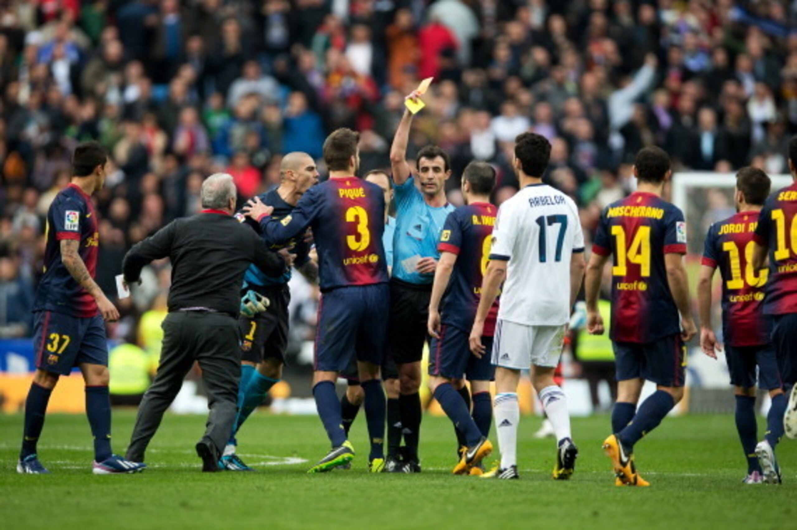 MADRID, SPAIN - MARCH 02:  Referee Miguel Perez (C) pulls a red card for goalkeeper Victor Valdes (L) of Barcelona, held back by teammates, after the final whistle of the la Liga match between Real Madrid CF and FC Barcelona at Estadio Santiago Bernabeu o