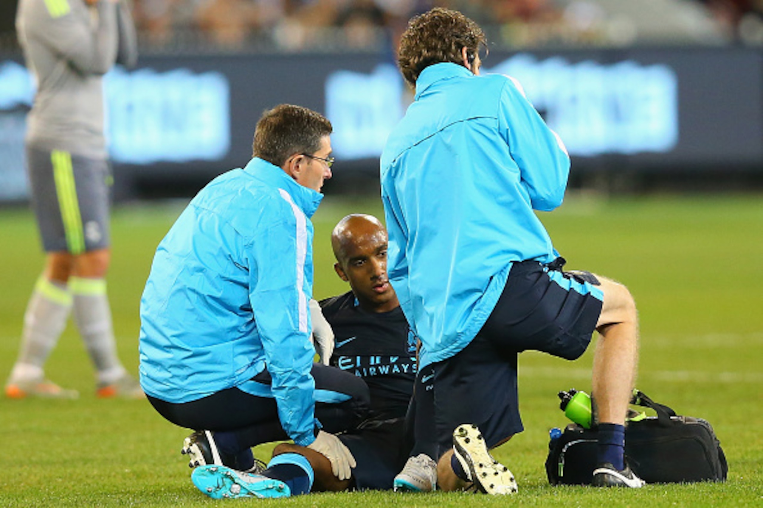 MELBOURNE, AUSTRALIA - JULY 24: Fabian Delph of Manchester City is attended to by trainers during the International Champions Cup match between Real Madrid and Manchester City at Melbourne Cricket Ground on July 24, 2015 in Melbourne, Australia.  (Photo b