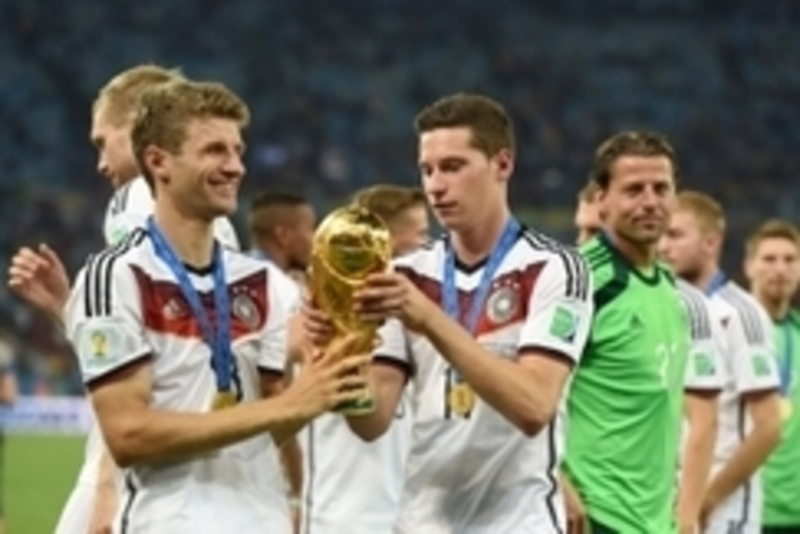 July 13, 2014; Rio de Janeiro, BRAZIL; Germany midfielder Thomas Muller (13) and Germany midfielder Julian Draxler (14) celebrate with the world cup trophy after the championship match of the 2014 World Cup against the Argentina at Maracana Stadium. Germa July 13, 2014; Rio de Janeiro, BRAZIL; Germany midfielder Thomas Muller (13) and Germany midfielder Julian Draxler (14) celebrate with the world cup trophy after the championship match of the 2014 World Cup against the Argentina at Maracana Stadium. Germa