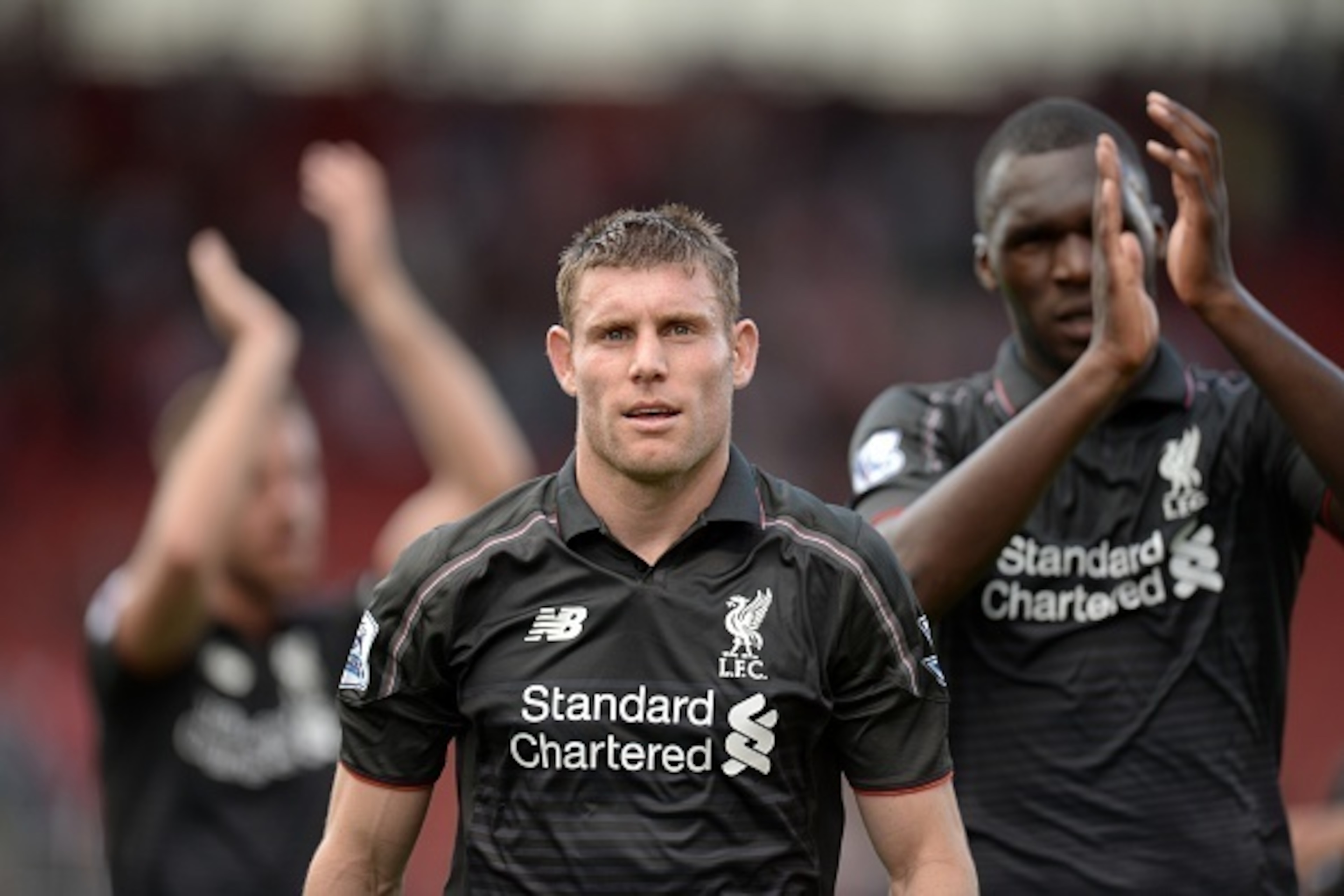 Liverpool's English midfielder James Milner (C) leaves the pitch at the end of the English Premier League football match between Stoke City and Liverpool at the Britannia Stadium in Stoke-on-Trent, central England on August 9, 2015. Liverpool won the game