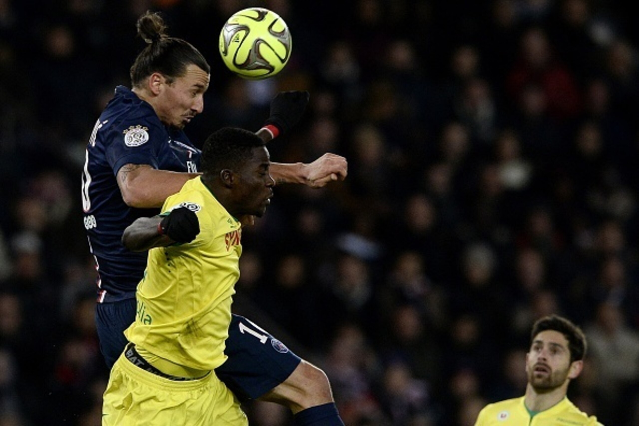 Nantes' Senegalese defender Papy Djilobodji jumps to head the ball with Paris Saint-Germain's Swedish forward Zlatan Ibrahimovic (L) during the French L1 football match between Paris Saint-Germain (PSG) and Nantes at the Parc des Princes stadium in Paris 
