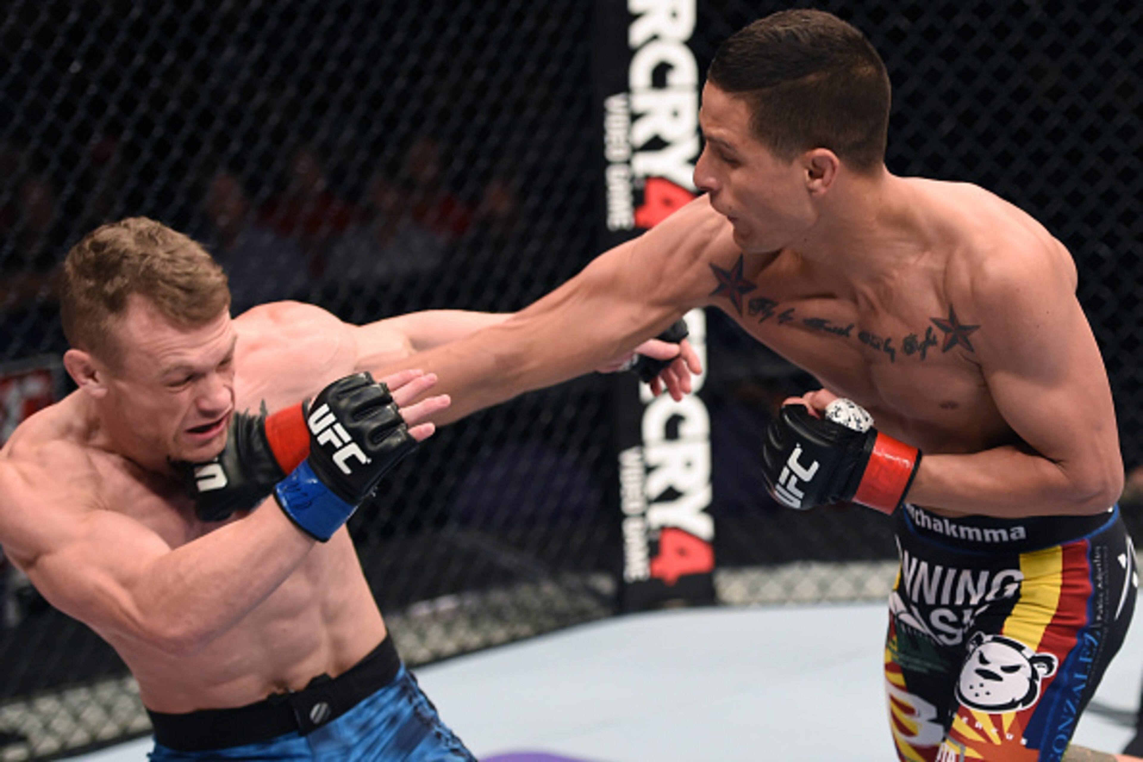 PHOENIX, AZ - DECEMBER 13:  (R-L) Anthony Birchak punches Ian Entwistle in their bantamweight fight during the UFC Fight Night event at the U.S. Airways Center on December 13, 2014 in Phoenix, Arizona.  (Photo by Josh Hedges/Zuffa LLC/Zuffa LLC via Getty 