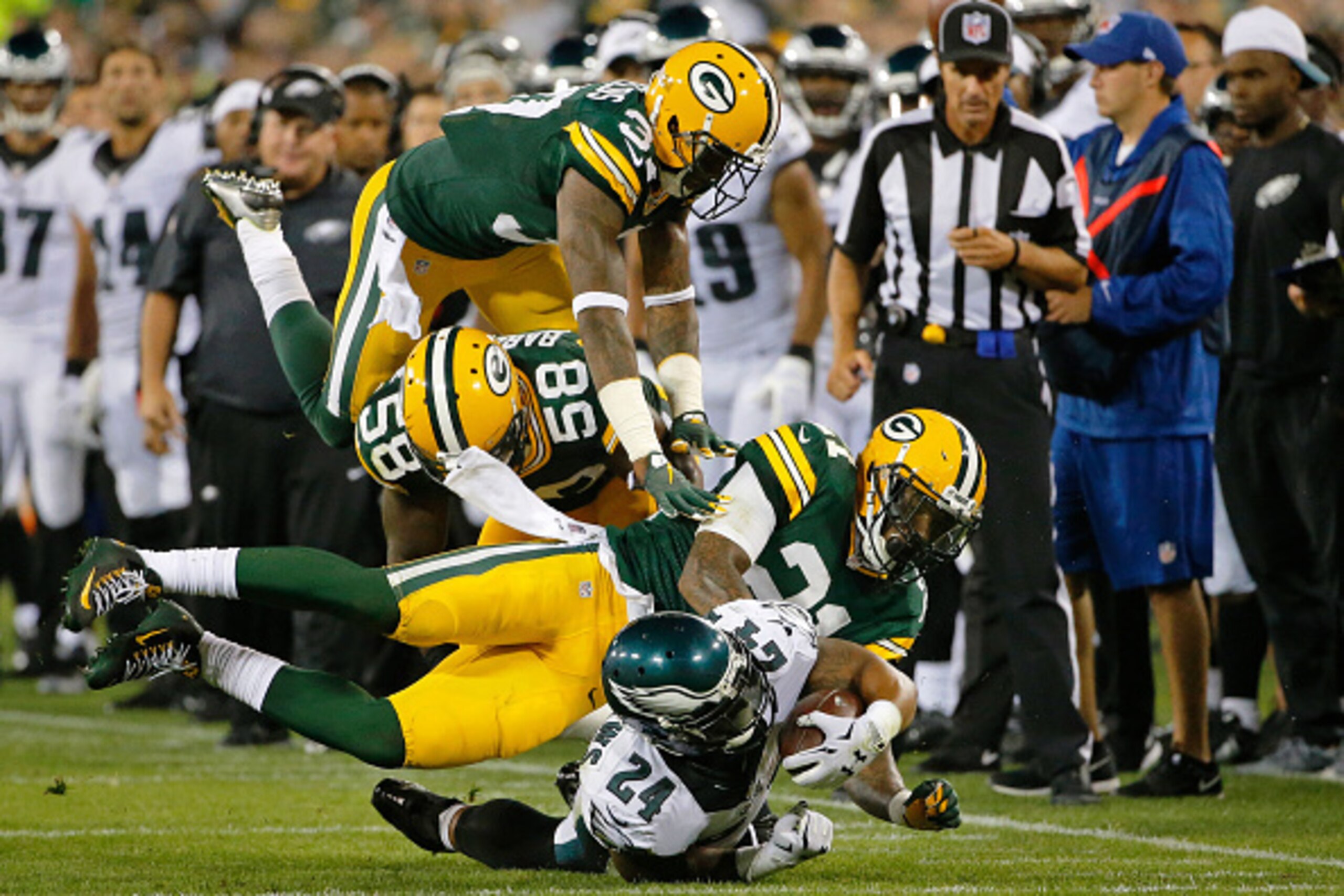 GREEN BAY, WI - AUGUST 29: Ryan Mathews #24 of the Philadelphia Eagles is tackled by Ha Ha Clinton-Dix #21 of the Green Bay Packers (bottom), Sam Barrington #58 (middle) and Sam Shields #37 (top) during a preseason game at Lambeau Field on August 29, 2015