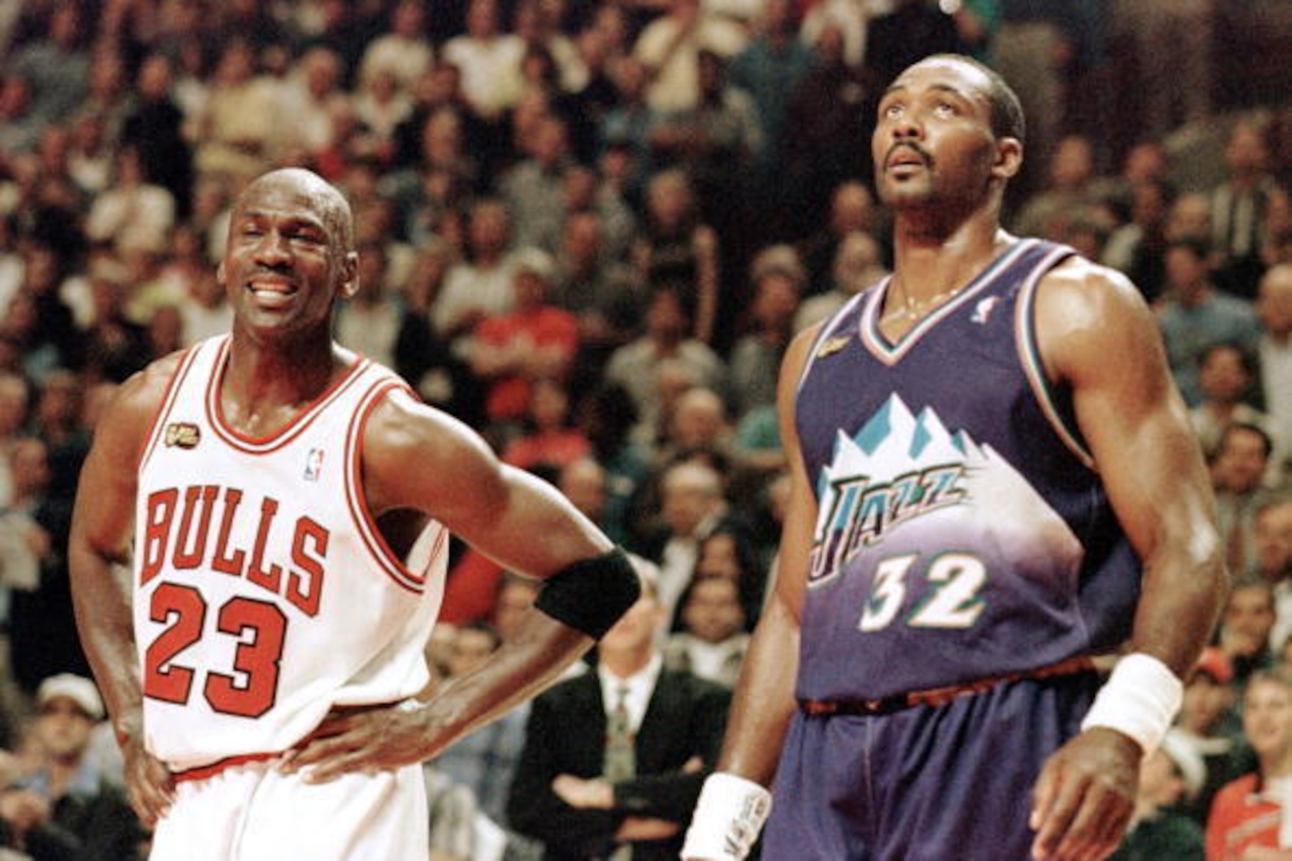 CHICAGO, UNITED STATES: Michael Jordan (L) of the Chicago Bulls smiles while standing next to Karl Malone of the Utah Jazz 07 June in the first half of game three of the NBA Finals at the United Center in Chicago, IL. The seven game series is tied at 1-1 CHICAGO, UNITED STATES: Michael Jordan (L) of the Chicago Bulls smiles while standing next to Karl Malone of the Utah Jazz 07 June in the first half of game three of the NBA Finals at the United Center in Chicago, IL. The seven game series is tied at 1-1