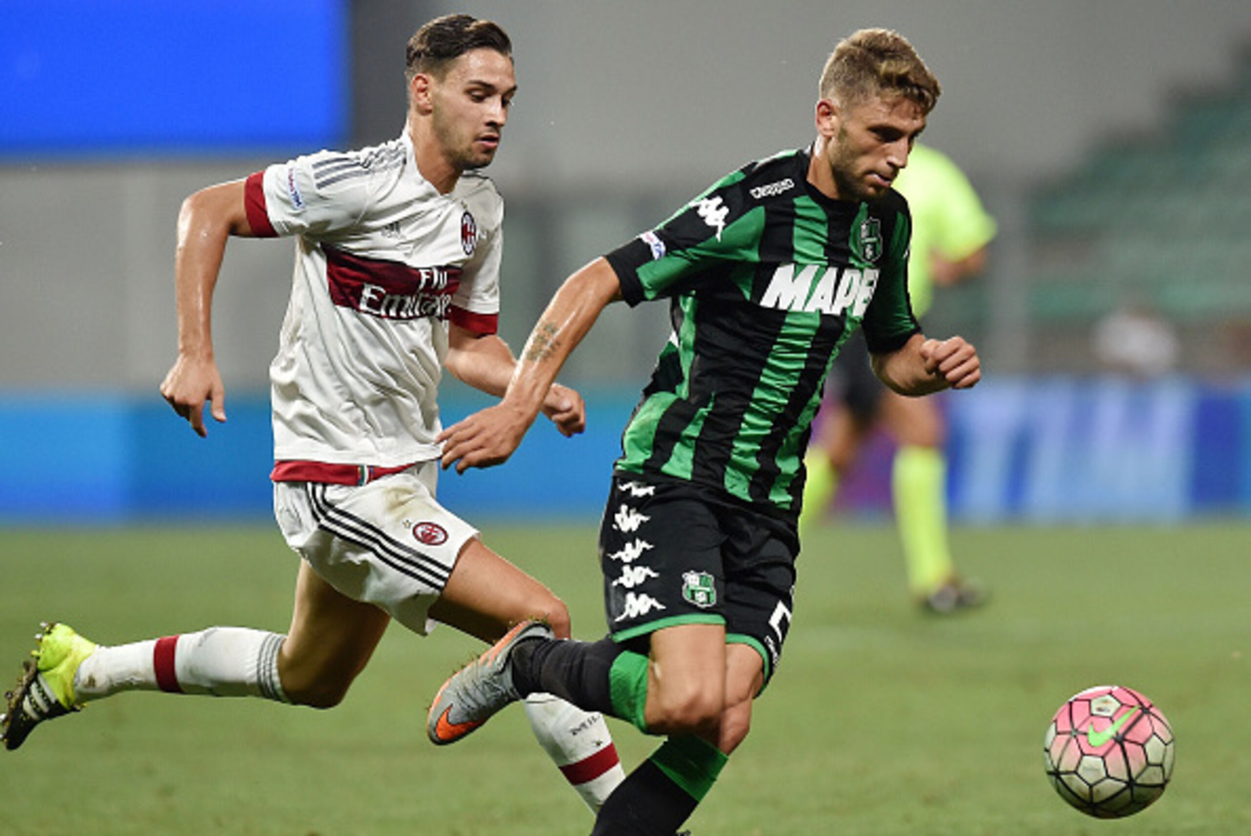 REGGIO NELL'EMILIA, ITALY - AUGUST 12:  Mattia De Sciglio of Milan and Domenico Berardi of Sassuolo in action during the TIM pre-season tournament match between AC Milan and US Sassuolo Calcio at Mapei Stadium - Città del Tricolore on August 12, 2015 in R