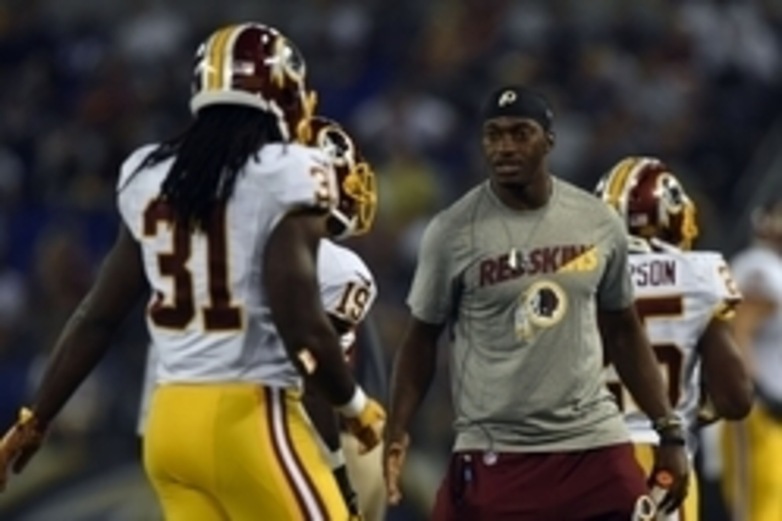 Aug 29, 2015; Baltimore, MD, USA; Washington Redskins quarterback Robert Griffin III (10) greets teammates as they leave he field after scoring during the third quarter against the Baltimore Ravens  at M&T Bank Stadium. Mandatory Credit: Tommy Gilligan-US