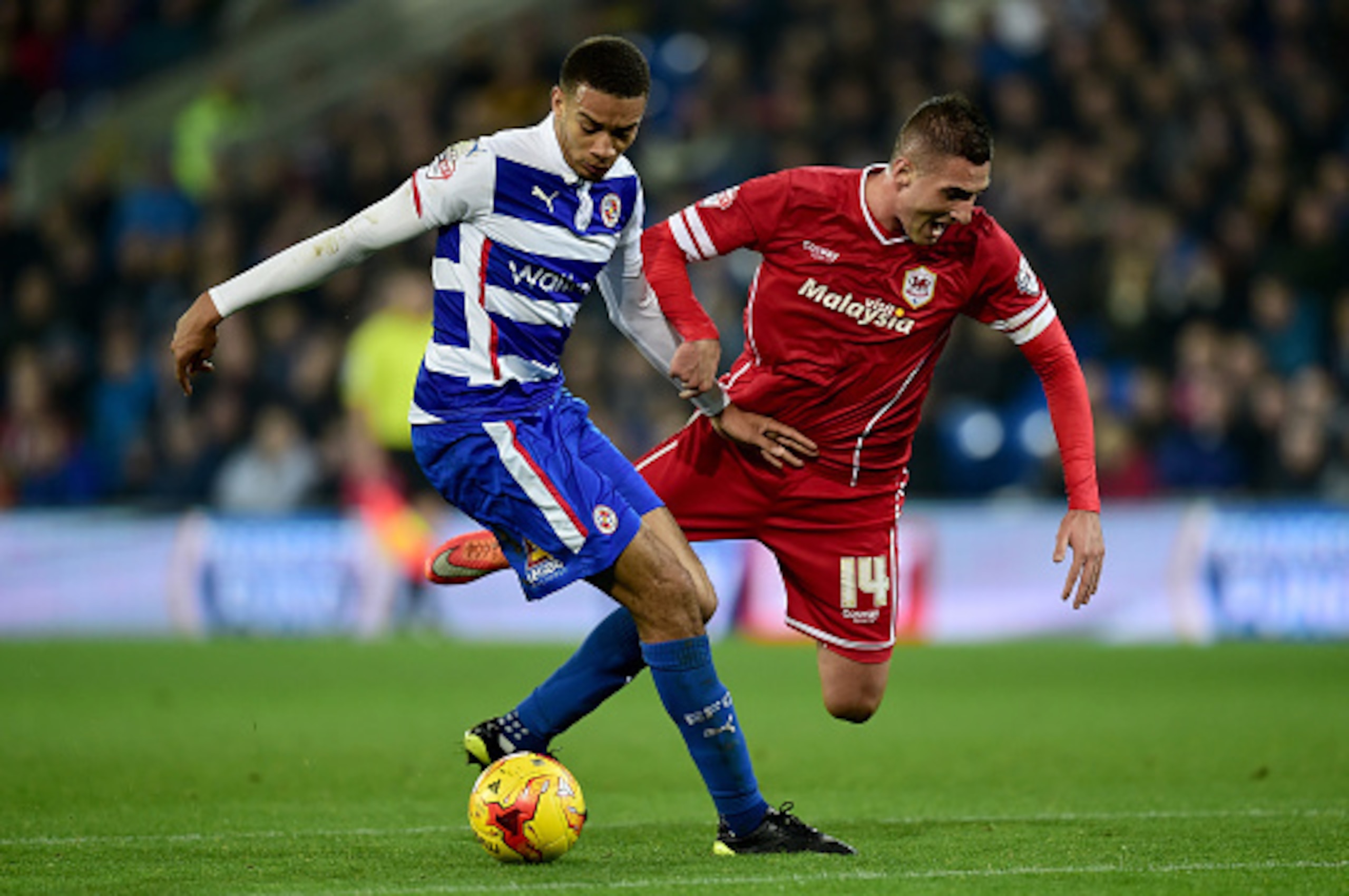 CARDIFF, WALES - NOVEMBER 21:  Reading player Michael Hector (l) challenges Federico Macheda of Cardiff during the Sky Bet Championship match between Cardiff City and Reading at Cardiff City Stadium on November 21, 2014 in Cardiff, Wales.  (Photo by Stu F