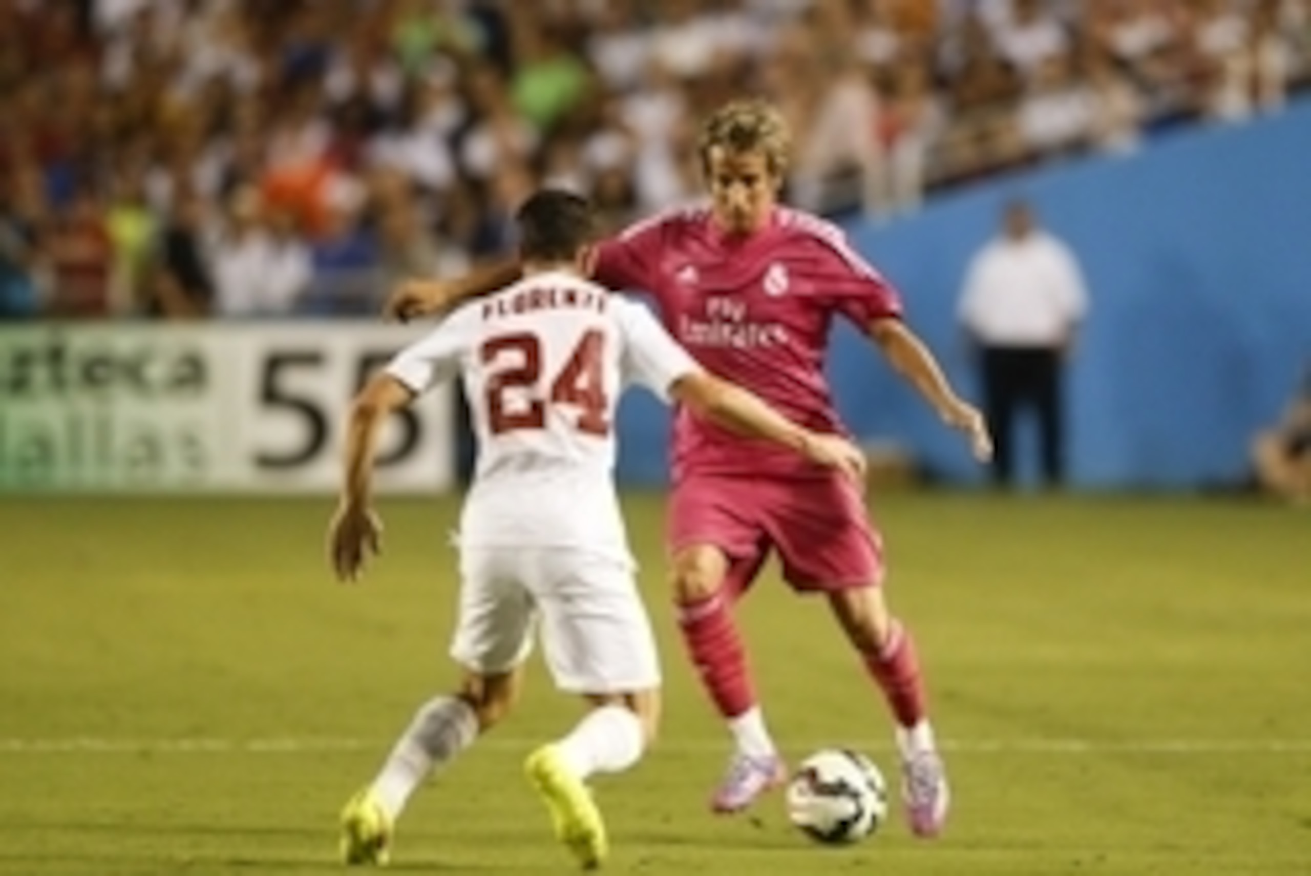 Jul 29, 2014; Dallas, TX, USA; Real Madrid defender Fabio Coentrao (5) dribbles as AS Roma midfielder Alessandro Florenzi (24) defends during the game at Cotton Bowl Stadium. Mandatory Credit: Kevin Jairaj-USA TODAY Sports