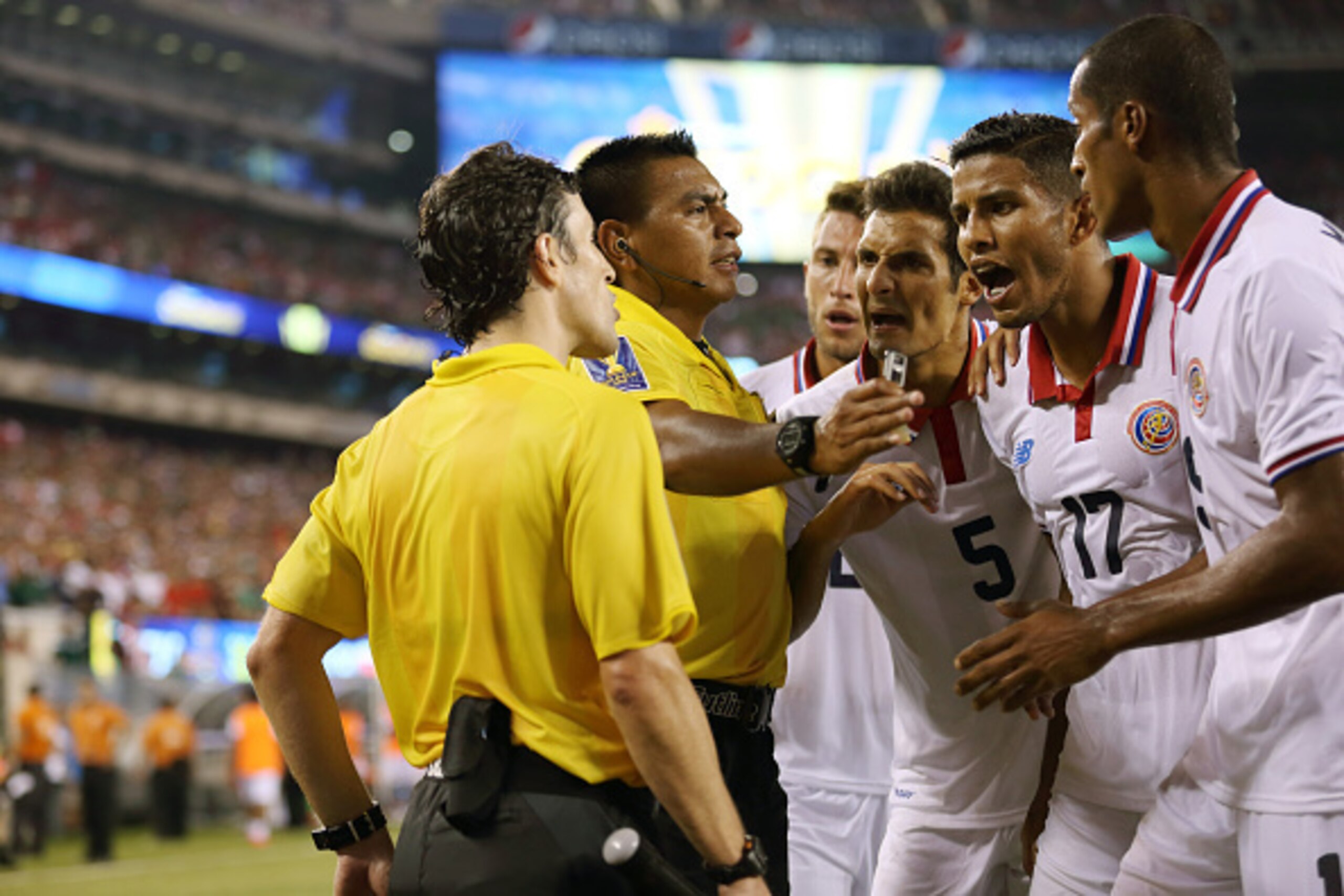 EAST RUTHERFORD, UNITED STAES - JULY 19: Francisco Calvo, Johan Venegas and Junior Diaz of Costa Rica appeal to the assistant referee about the last minute penalty awarded to Mexico during the Gold Cup Quarter Final between Mexico and Costa Rica at MetL EAST RUTHERFORD, UNITED STAES - JULY 19: Francisco Calvo, Johan Venegas and Junior Diaz of Costa Rica appeal to the assistant referee about the last minute penalty awarded to Mexico during the Gold Cup Quarter Final between Mexico and Costa Rica at MetL