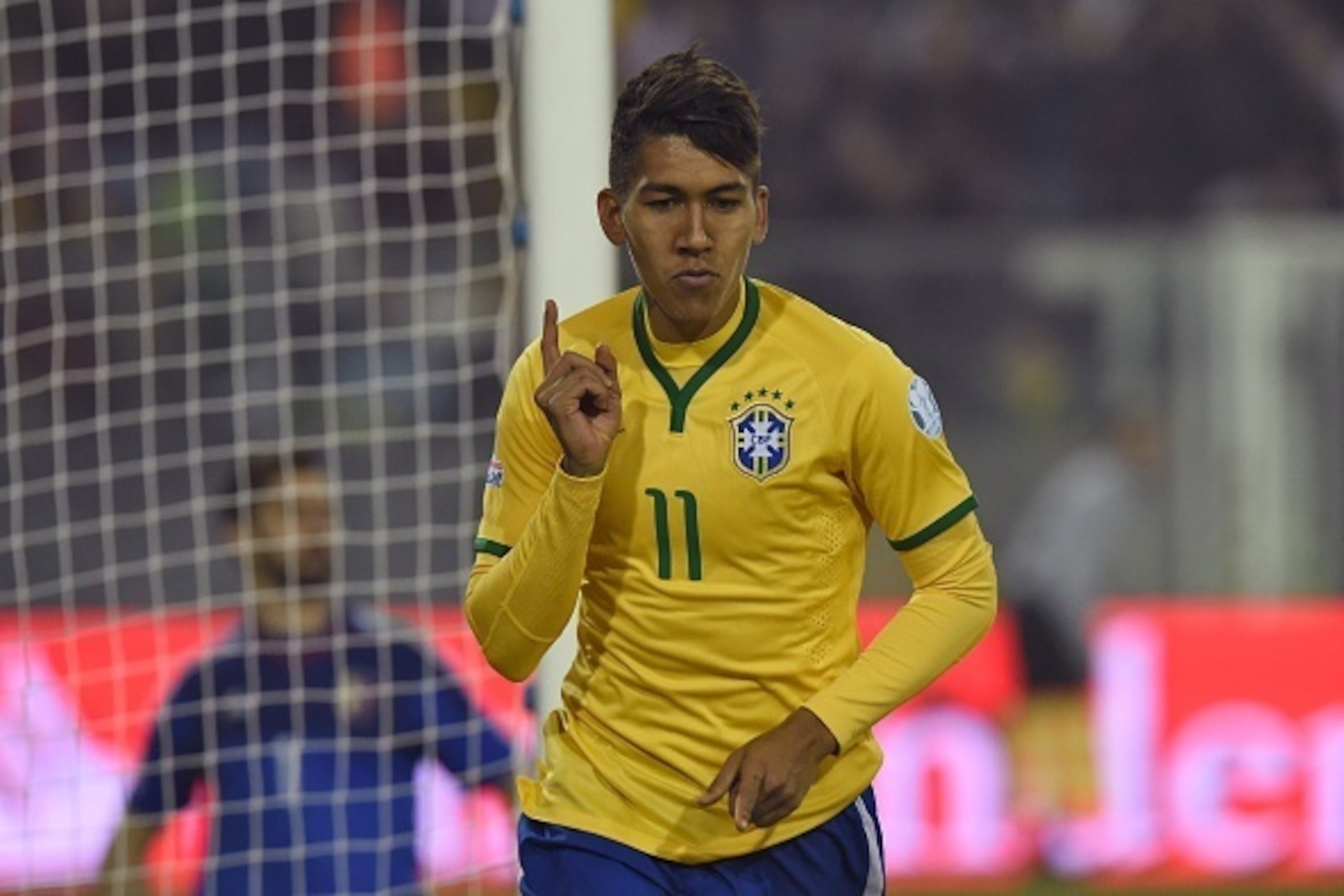 Brazil's forward Roberto Firmino celebrates after scoring the team's second goal against Venezuela during their 2015 Copa America football championship match, at the Estadio Monumental David Arellano in Santiago, on June 21, 2015. AFP PHOTO / PABLO POR Brazil's forward Roberto Firmino celebrates after scoring the team's second goal against Venezuela during their 2015 Copa America football championship match, at the Estadio Monumental David Arellano in Santiago, on June 21, 2015. AFP PHOTO / PABLO POR
