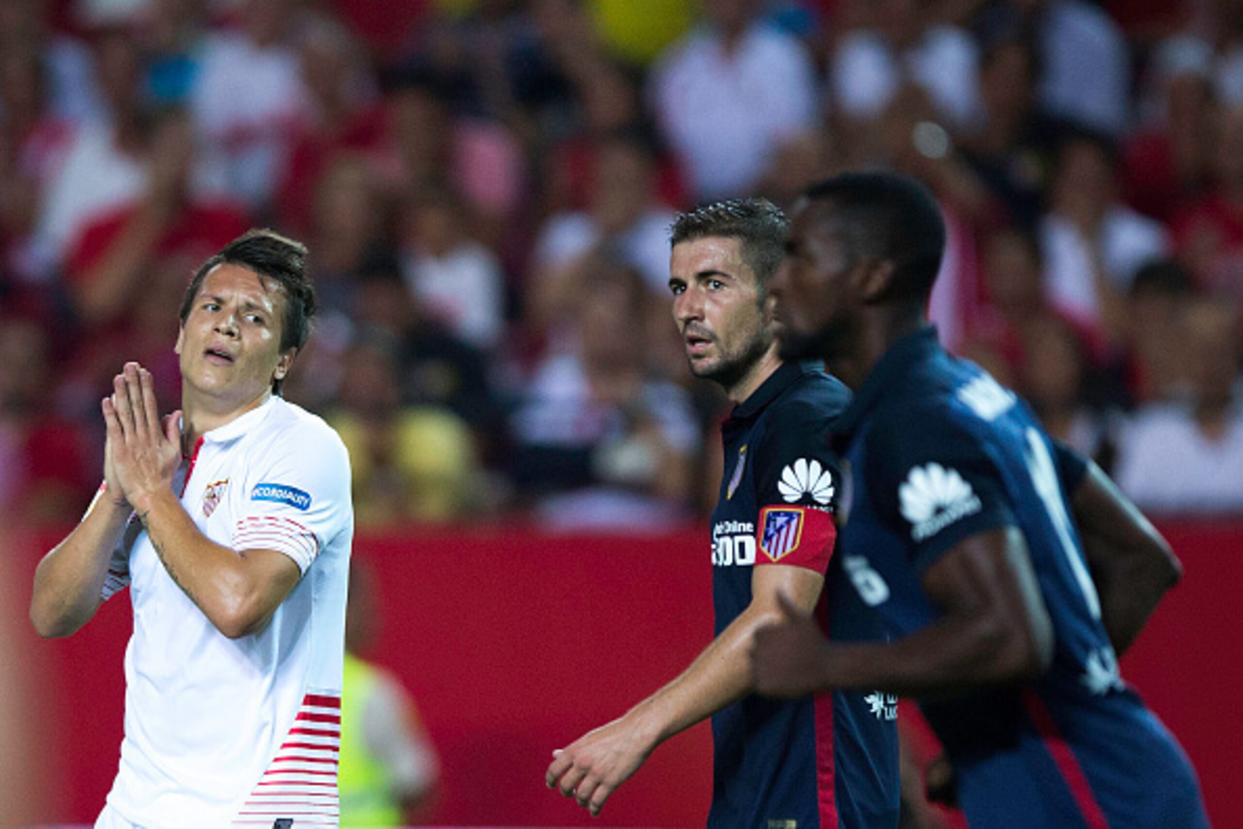 SEVILLE, SPAIN - AUGUST 30: Yevhen Konoplyanka (L) of Sevilla FC reacts as he fail to score close to Gabi Fernandez (2ndR) of Atletico de Madrid and his teammate Jackson Arley Martinez (R) during the La Liga match between Sevilla FC and Club Atletico de SEVILLE, SPAIN - AUGUST 30: Yevhen Konoplyanka (L) of Sevilla FC reacts as he fail to score close to Gabi Fernandez (2ndR) of Atletico de Madrid and his teammate Jackson Arley Martinez (R) during the La Liga match between Sevilla FC and Club Atletico de
