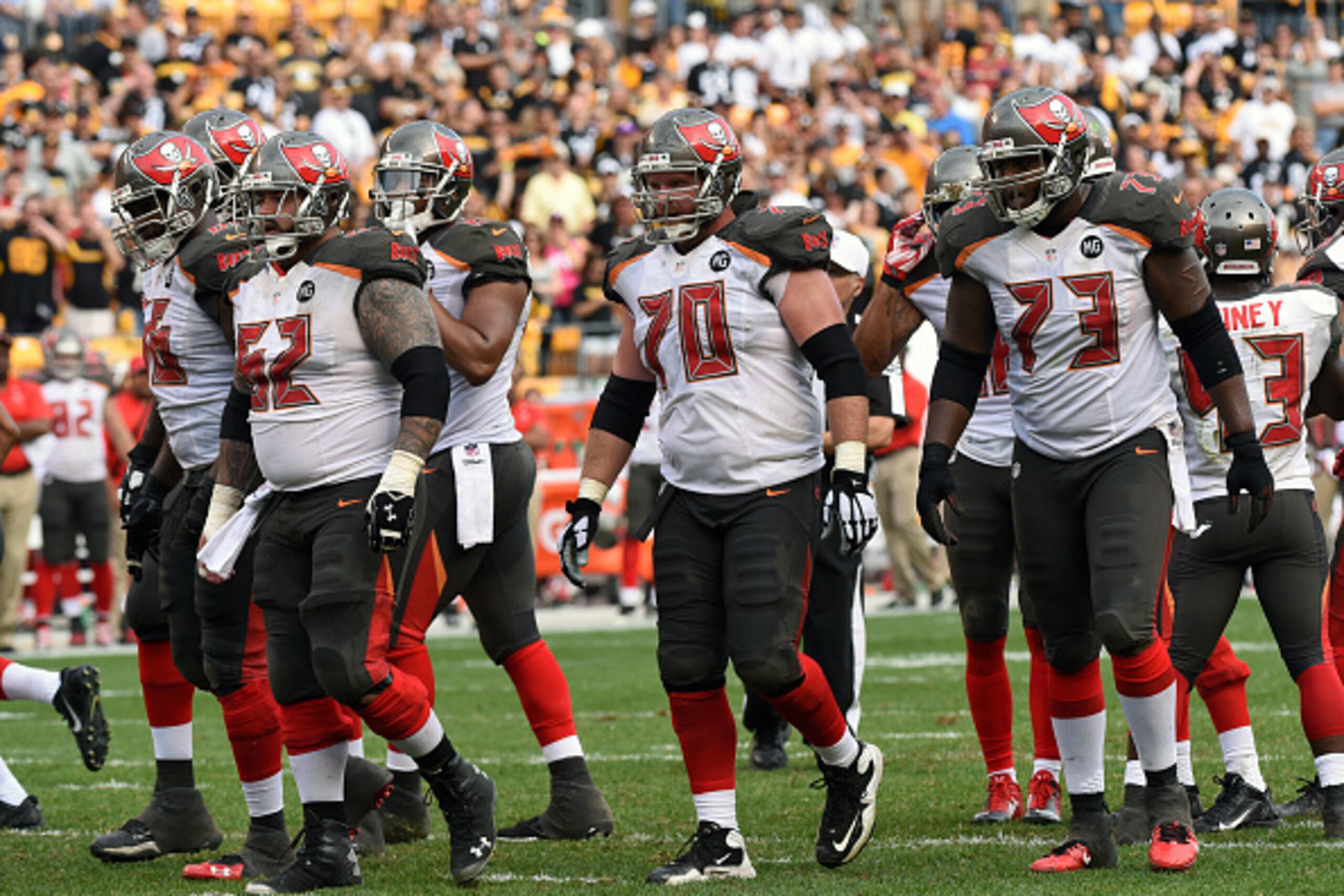 PITTSBURGH, PA - SEPTEMBER 28:  The offensive line of the Tampa Bay Buccaneers, including guard Patrick Omameh #66, center Evan Dietrich-Smith #62, guard Logan Mankins #70 and tackle Anthony Collins #73, walk to the line of scrimmage during a game against