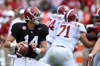 TUSCALOOSA, AL - APRIL 18:  Jake Coker #14 of the White team drops back to pass during the University of Alabama Crimson Tide A-day spring game at Bryant-Denny Stadium on April 18, 2015 in Tuscaloosa, Alabama.  (Photo by Stacy Revere/Getty Images)