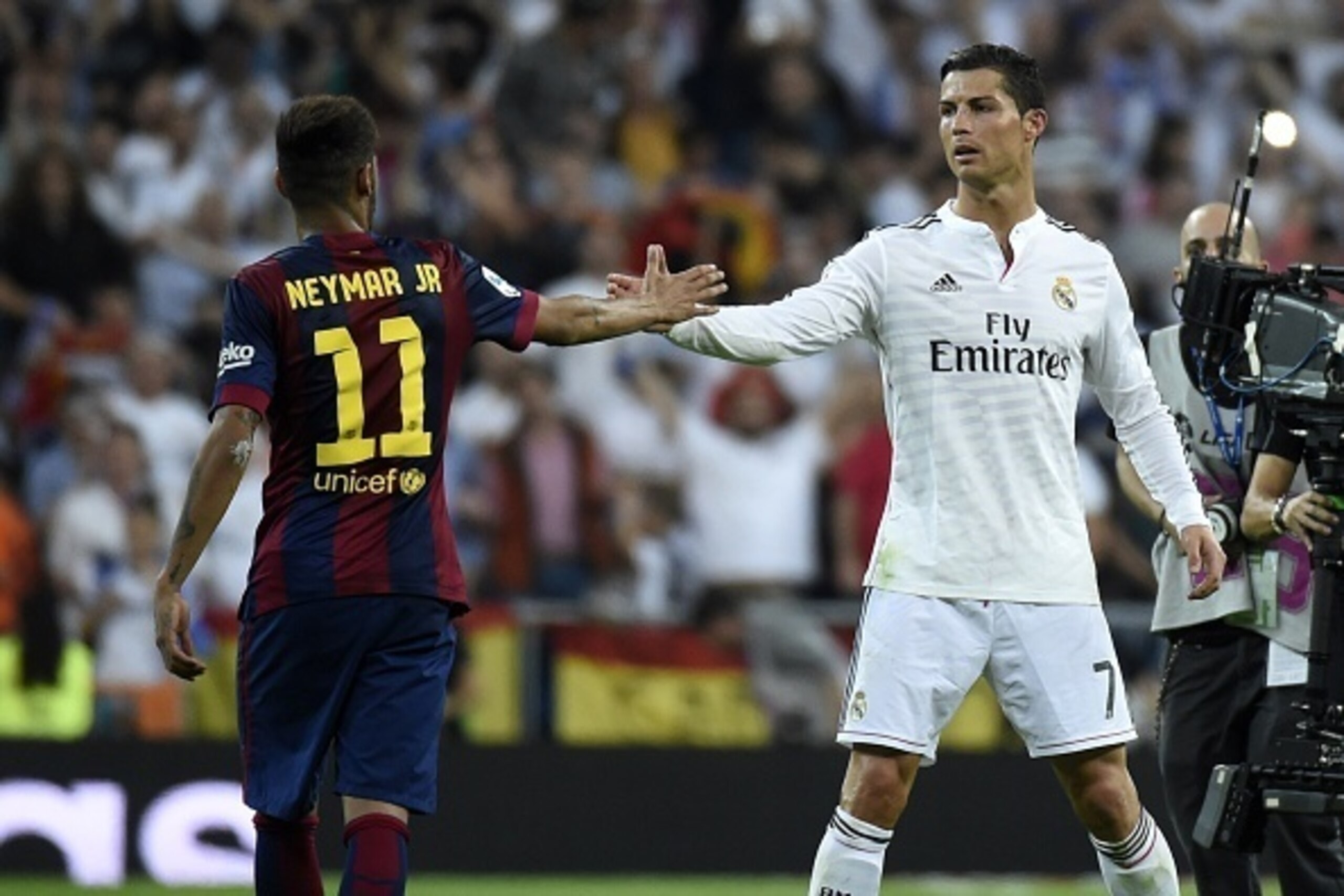 Barcelona's Brazilian forward Neymar da Silva Santos Junior (L) congratulates Real Madrid's Portuguese forward Cristiano Ronaldo on winning after the Spanish league 'Clasico' football match Real Madrid CF vs FC Barcelona at the Santiago Bernabeu stadium i
