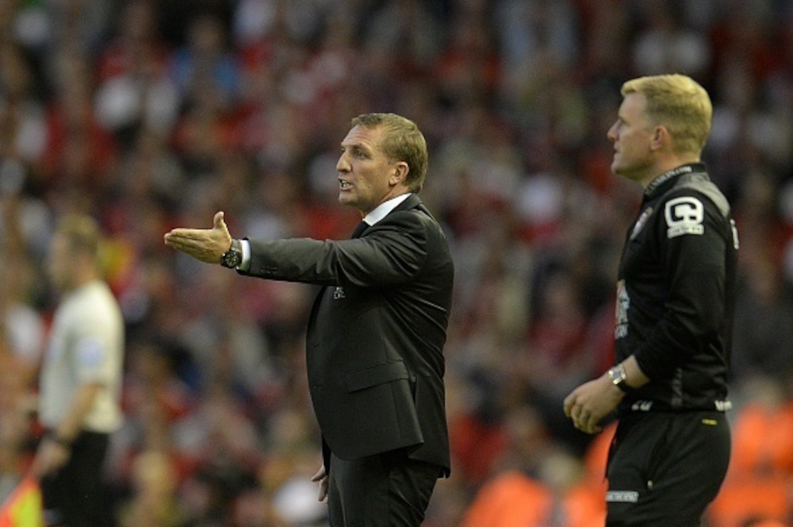 Liverpool's Northern Irish manager Brendan Rodgers (2nd R) instructs his team as Bournemouth's English manager Eddie Howe (R) looks on during the English Premier League football match between Liverpool and Bournemouth at the Anfield stadium in Liverpool, 