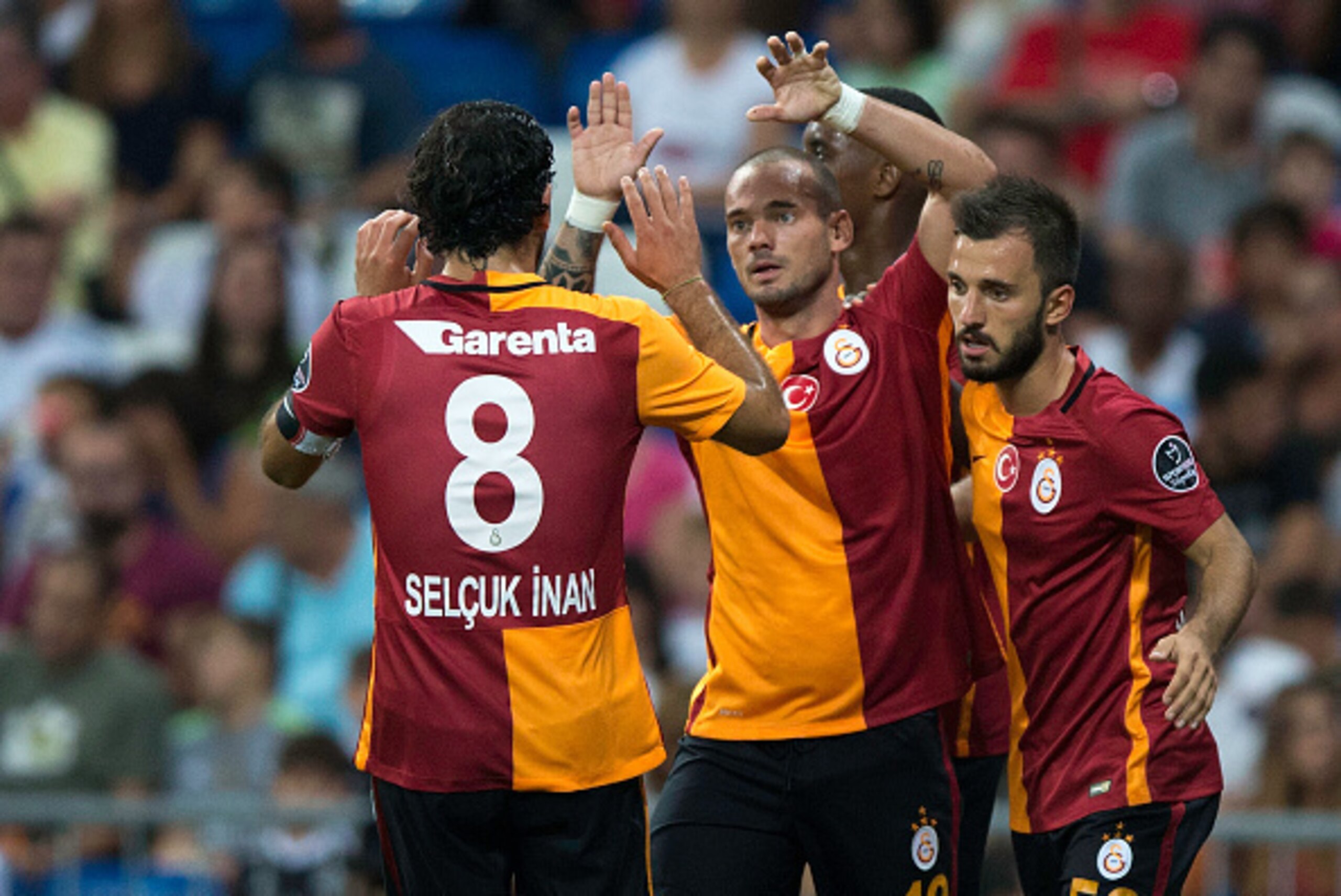 MADRID, SPAIN - AUGUST 18: Wesley Sneijder (2ndL) of Galatasaray AS celebrates scoring their opening goal with teammates during the Santiago Bernabeu Trophy match between Real Madrid CF and Galatasaray at Estadio Santiago Bernabeu on August 18, 2015 in MADRID, SPAIN - AUGUST 18: Wesley Sneijder (2ndL) of Galatasaray AS celebrates scoring their opening goal with teammates during the Santiago Bernabeu Trophy match between Real Madrid CF and Galatasaray at Estadio Santiago Bernabeu on August 18, 2015 in