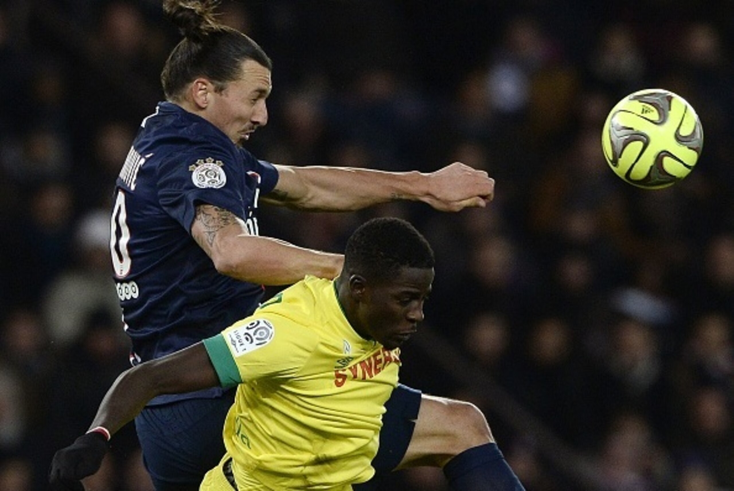 Nantes' Senegalese defender Papy Djilobodji heads the ball with Paris Saint-Germain's Swedish forward Zlatan Ibrahimovic (back) during the French L1 football match between Paris Saint-Germain (PSG) and Nantes at the Parc des Princes stadium in Paris on De