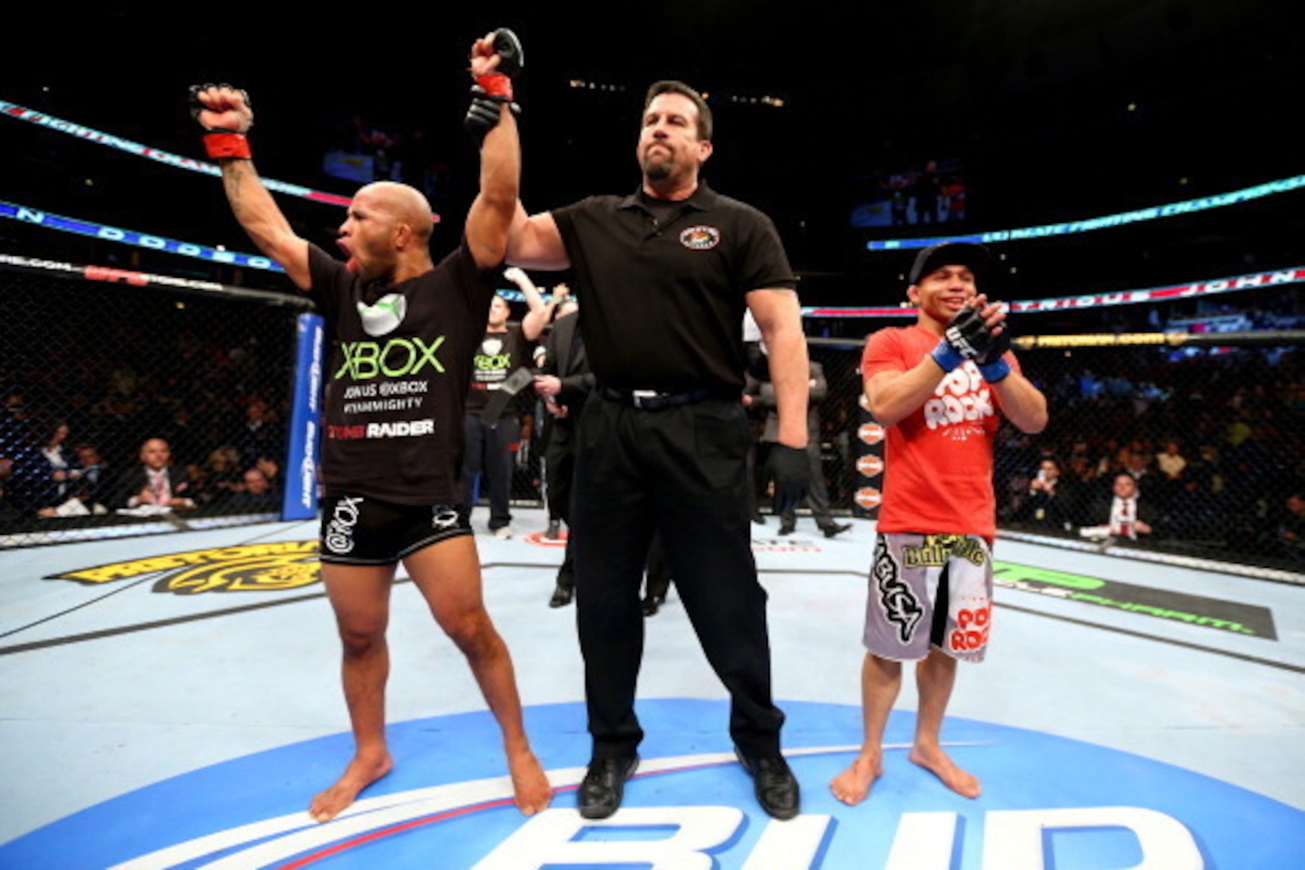 CHICAGO, IL - JANUARY 26:  Demetrious Johnson (L) celebrates defeating John Dodson (R) during thier Flyweight Championship Bout part of UFC on FOX at United Center on January 26, 2013 in Chicago, Illinois.  (Photo by Al Bello/Zuffa LLC/Zuffa LLC Via Getty
