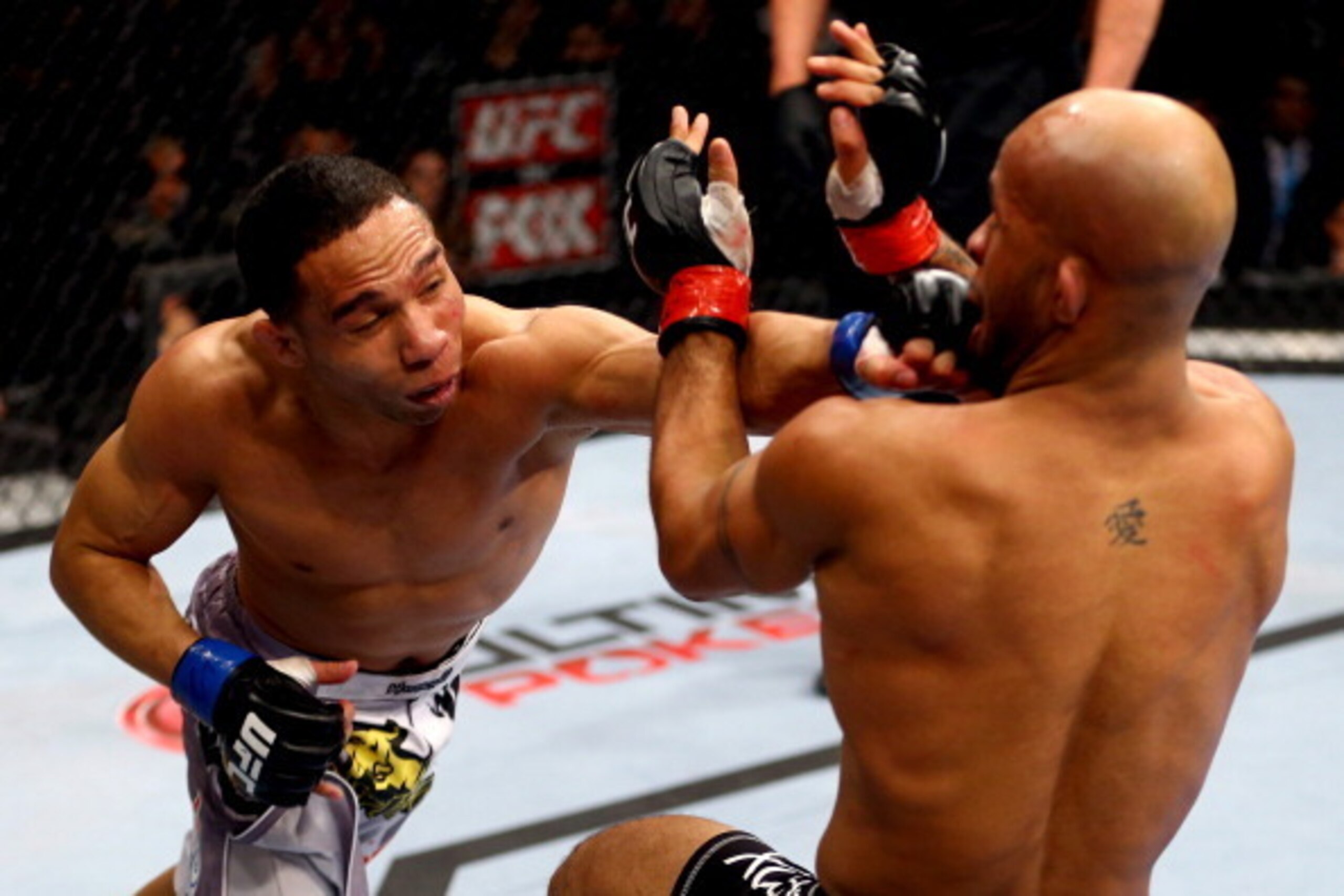 CHICAGO, IL - JANUARY 26:  John Dodson (L) punches Demetrious Johnson (R) during thier Flyweight Championship Bout part of UFC on FOX at United Center on January 26, 2013 in Chicago, Illinois.  (Photo by Al Bello/Zuffa LLC/Zuffa LLC Via Getty Images)