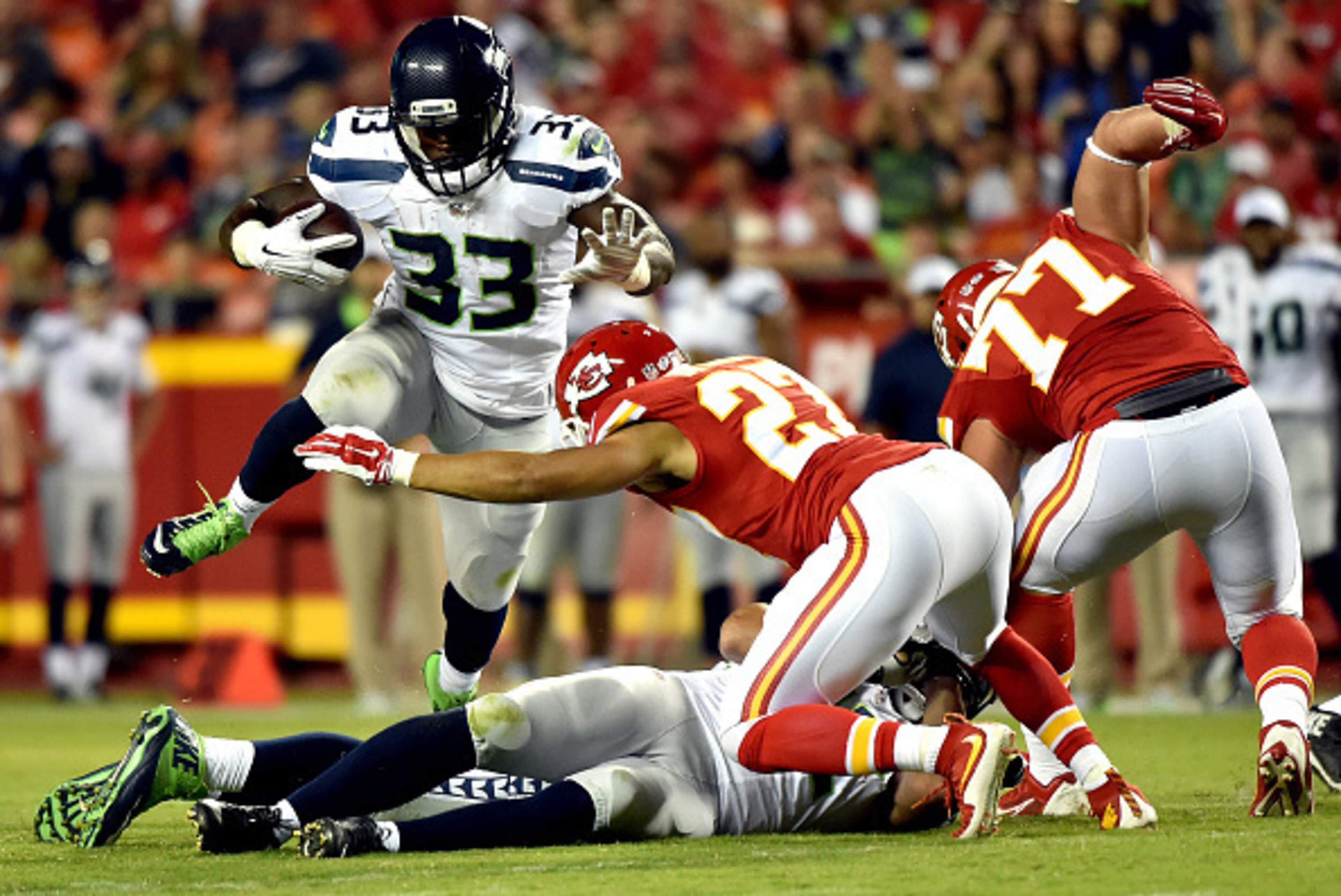 KANSAS CITY, MO - AUGUST 21:  Running back Christine Michael #33 of the Seattle Seahawks carries the ball during the preseason game against the Kansas City Chiefs at Arrowhead Stadium on August 21, 2015 in Kansas City, Missouri.  (Photo by Peter Aiken/Get