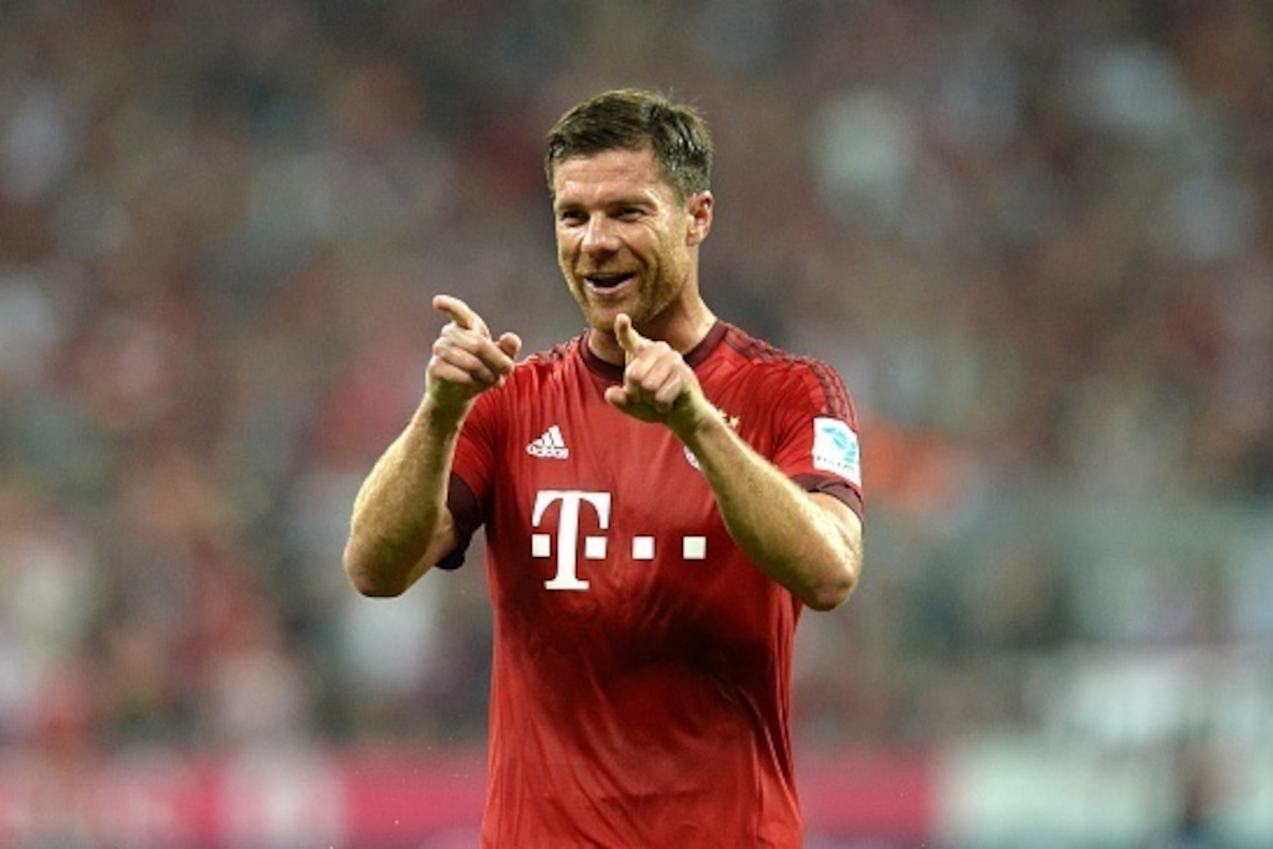 Bayern Munich's Spanish midfielder Xabi Alonso gestures during the German first division Bundesliga football match FC Bayern Munich vs Hamburger SV at the Allianz Arena in Munich, southern Germany, on August 14, 2015. The match was the first of the 2015/2