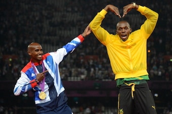 Jamaica's 4X100 relay gold medalist Usain Bolt (R) and Britain's 5000m gold medalist Mohamed Farah pose after the athletics event during the London 2012 Olympic Games on August 11, 2012 in London.   AFP PHOTO / JOHANNES EISELE        (Photo credit should 