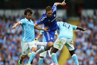 MANCHESTER, ENGLAND - AUGUST 16: Nemanja Matic of Chelsea is tackled by David Silva (L) and Yaya Toure of Manchester City during the Barclays Premier League match between Manchester City and Chelsea at the Etihad Stadium on August 16, 2015 in Manchester, 