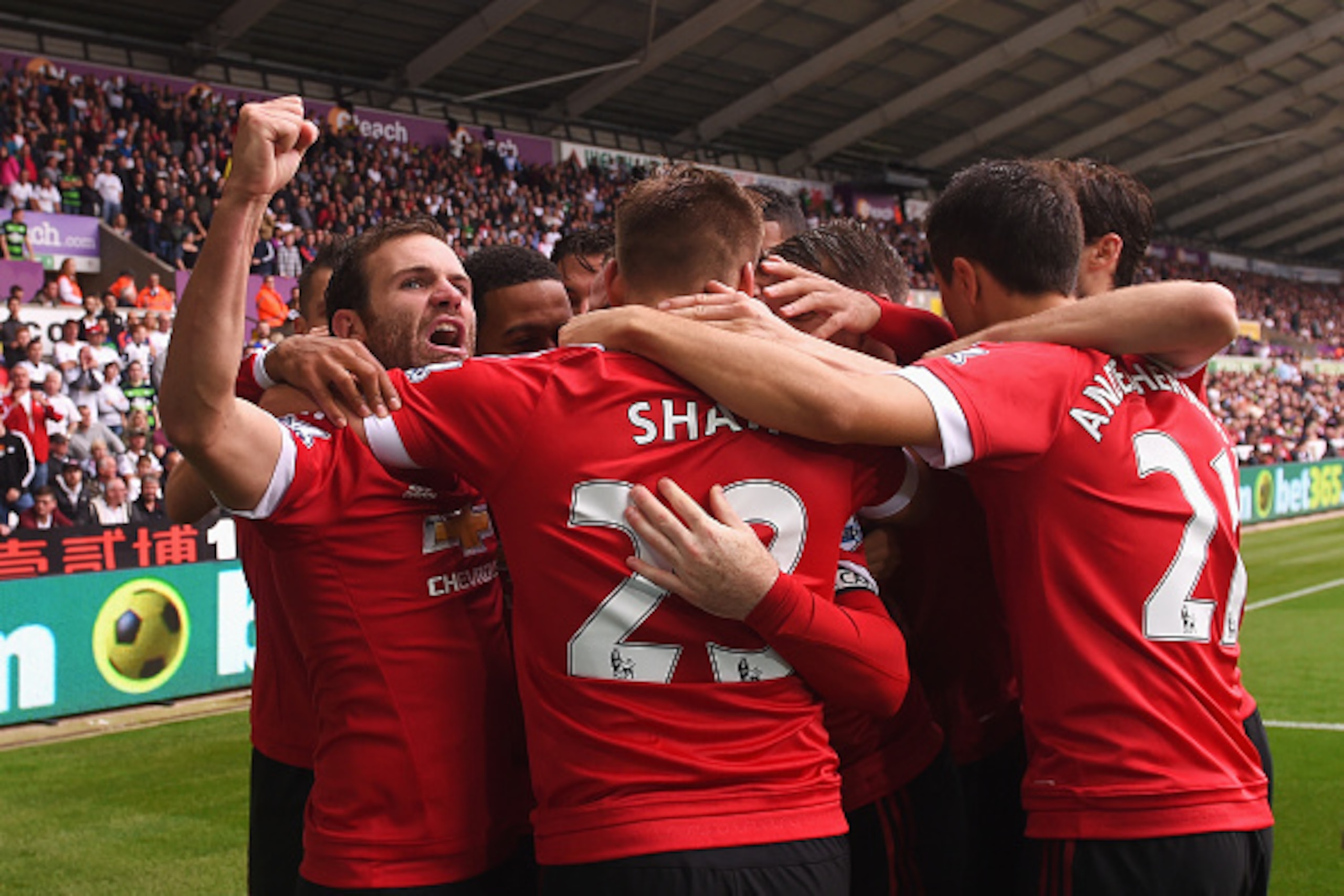 SWANSEA, WALES - AUGUST 30:  Juan Mata of Manchester United celebrates scoring the opening goal with team mates during the Barclays Premier League match between Swansea City and Manchester United at Liberty Stadium on August 30, 2015 in Swansea, Wales.  (