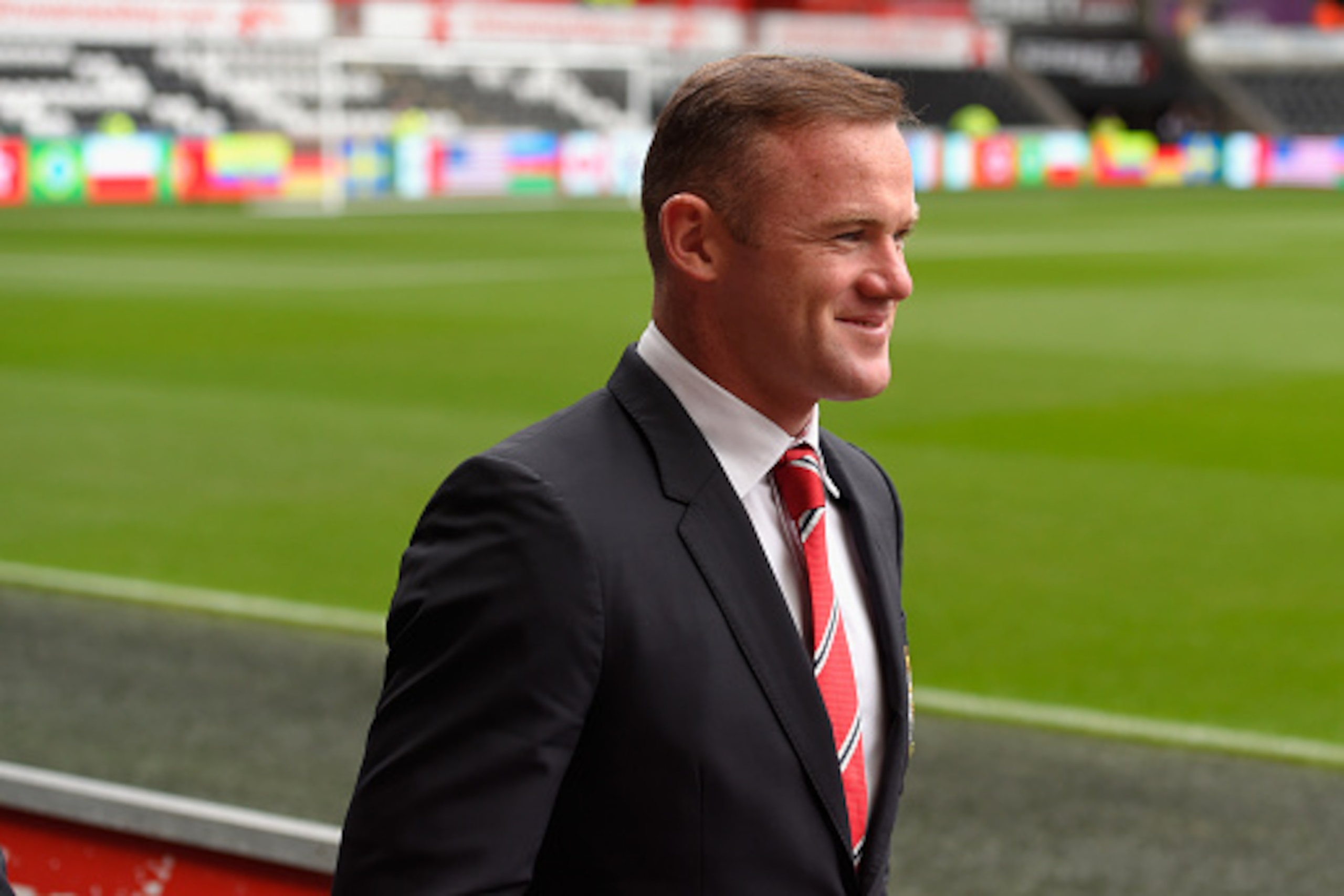 SWANSEA, WALES - AUGUST 30:  Manchester United captain Wayne Rooney raises a smile as he makes his way into the stadium before the Barclays Premier League match between Swansea City and Manchester United on August 30, 2015 in Swansea, United Kingdom.  (Ph