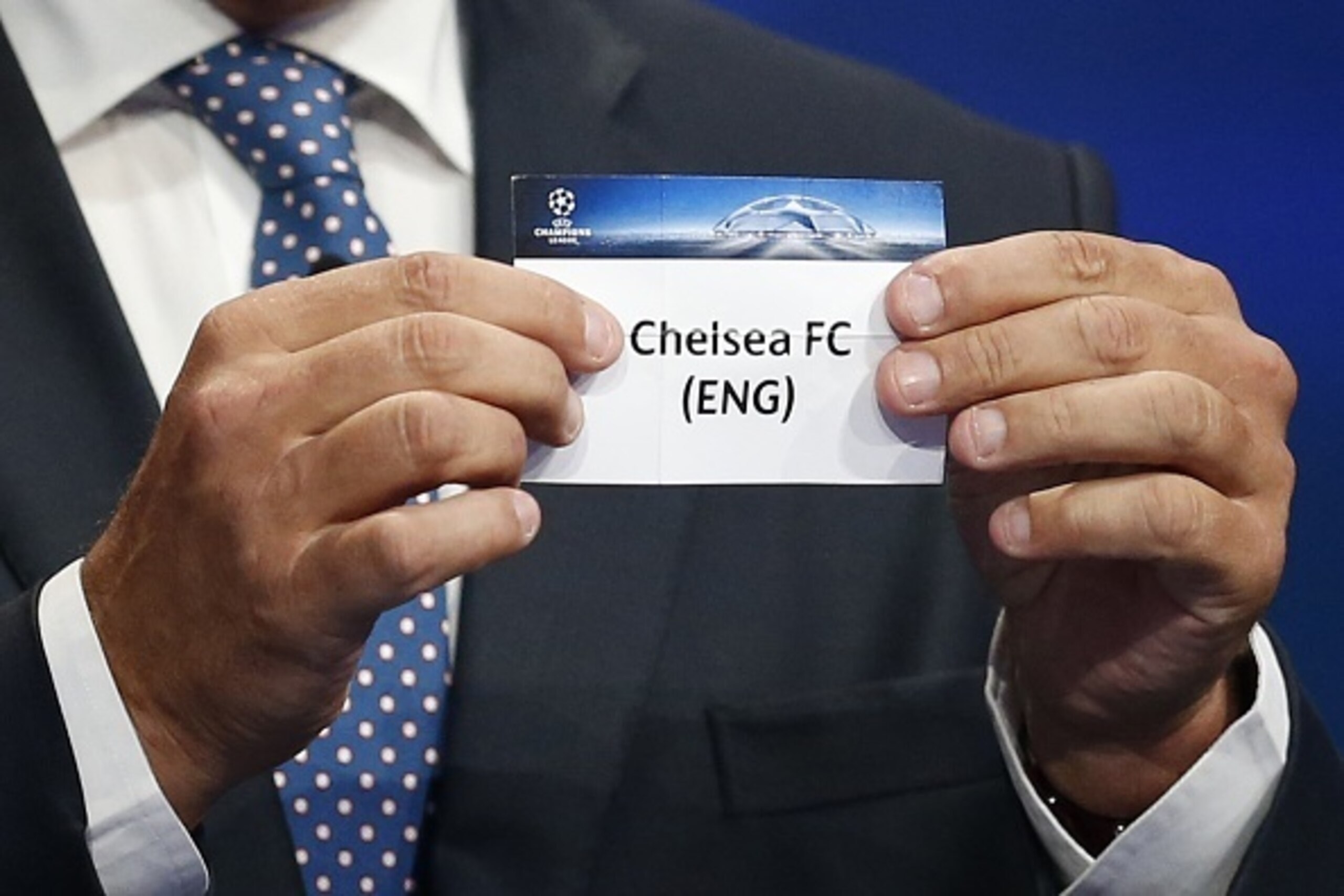 Former FC Barcelona player Andoni Zubizarreta shows the name of Chelsea during the UEFA Champions League Group stage draw ceremony, on August 27, 2015 in Monaco. AFP PHOTO / VALERY HACHE        (Photo credit should read VALERY HACHE/AFP/Getty Images)