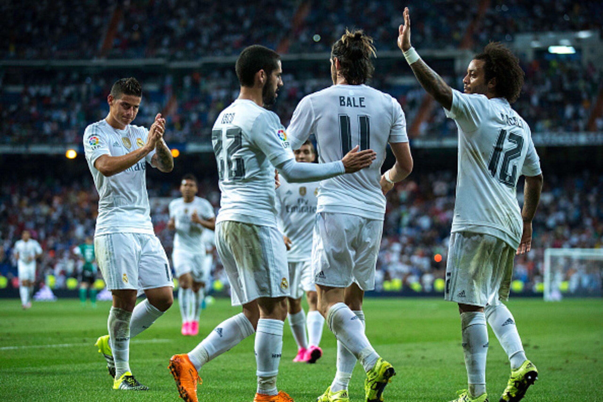 MADRID, SPAIN - AUGUST 29:  Gareth Bale (2ndR) of Real Madrid CF celebrates scoring their fifth goal with teammates James Rodriguez (L), Francisco Roman Alarcon alias Isco (2ndL) and Marcelo (R) during the La Liga match between Real Madrid CF and Real Bet